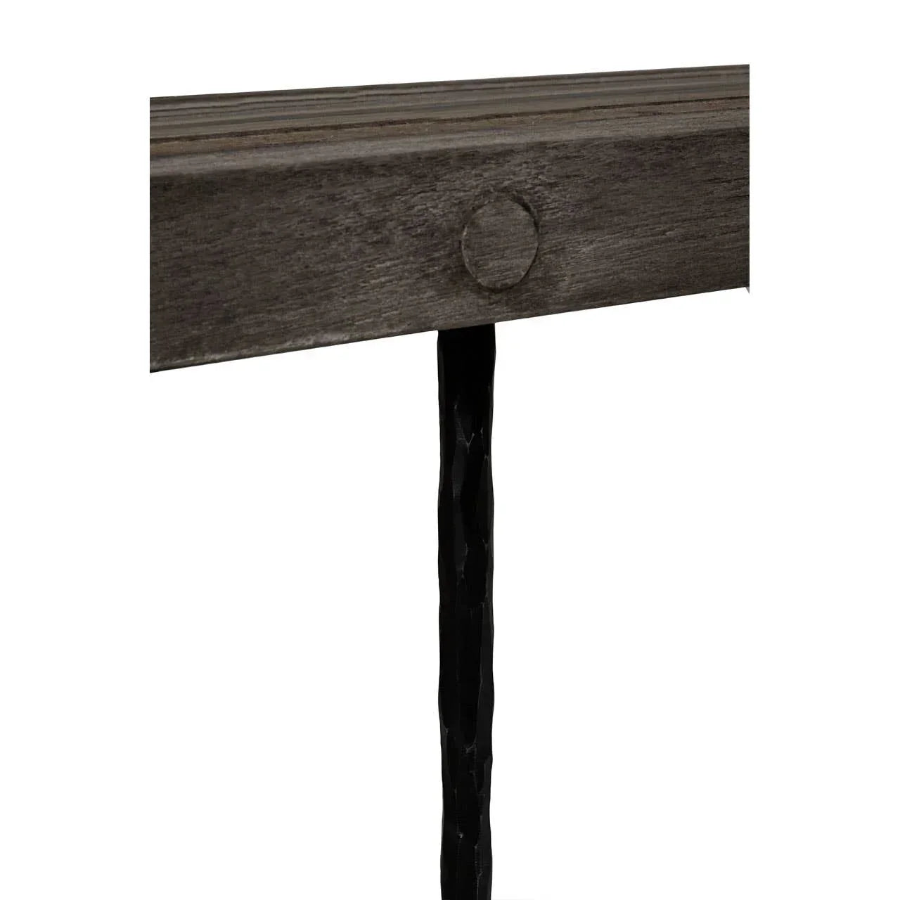 Closeup of wooden console table corner with textured black metal leg