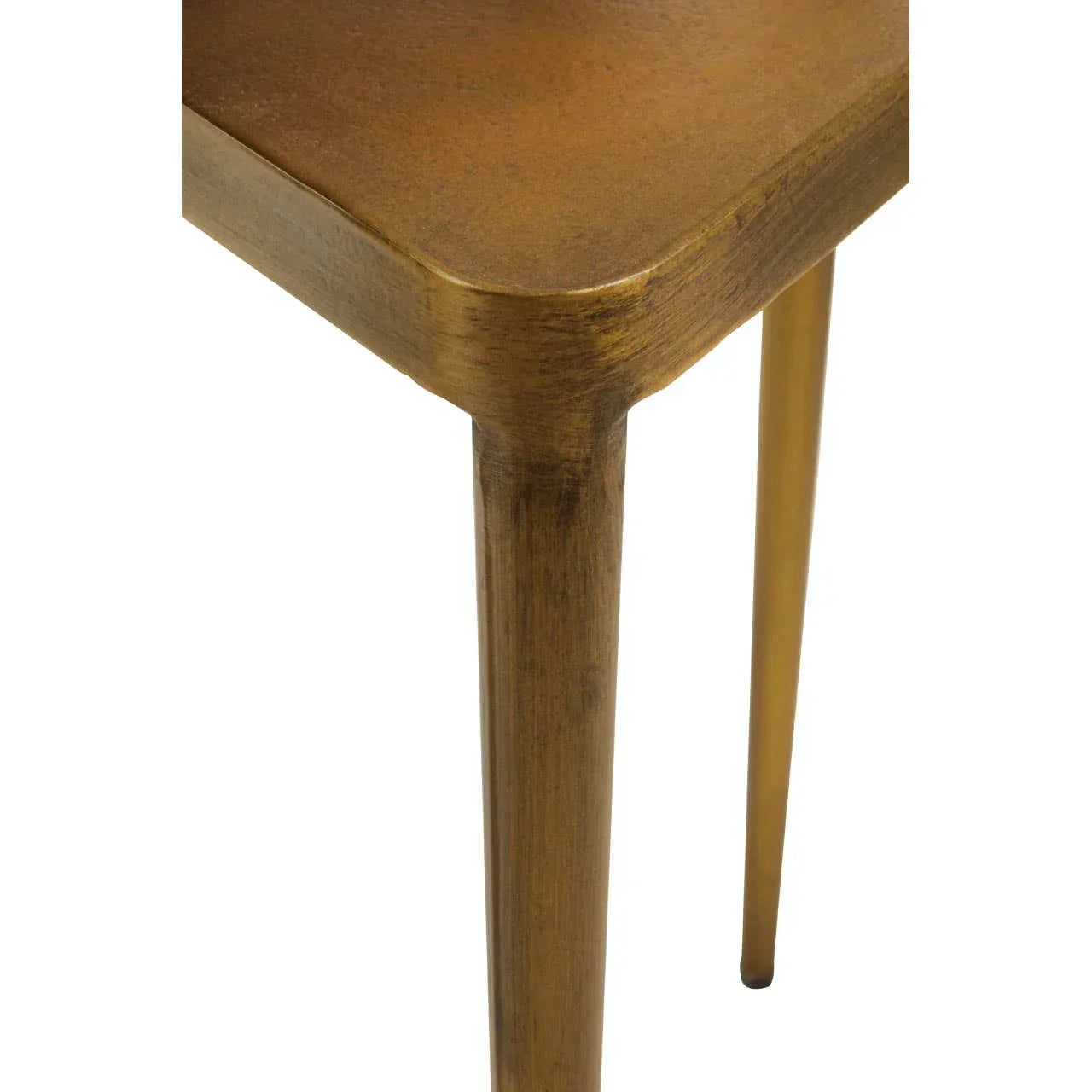 Closeup of gold metal table corner with tapered leg and smooth finish