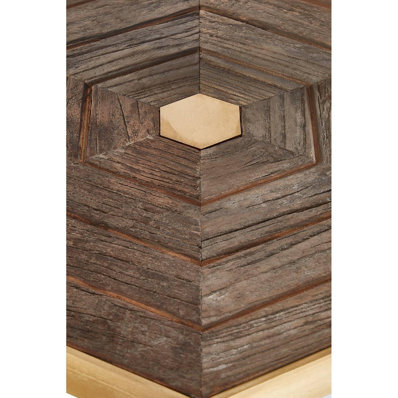 Close up of wooden coffee table surface with central gold hexagon and chevron pattern