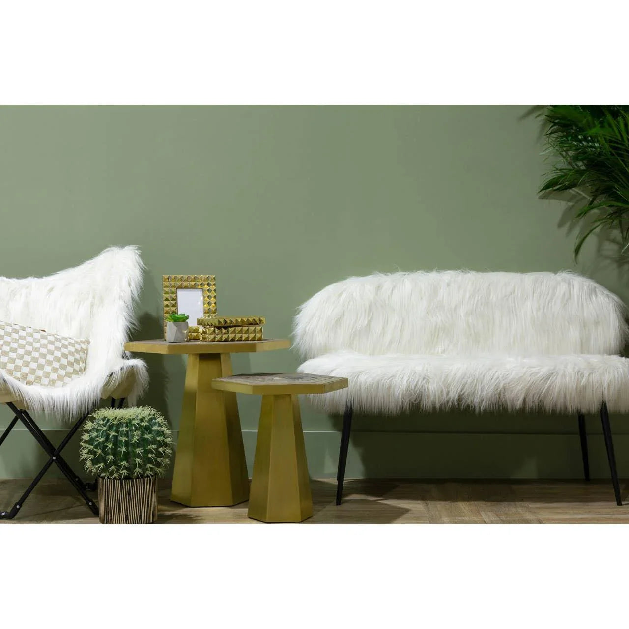 White faux fur accent chair and sofa with gold side tables in modern living room