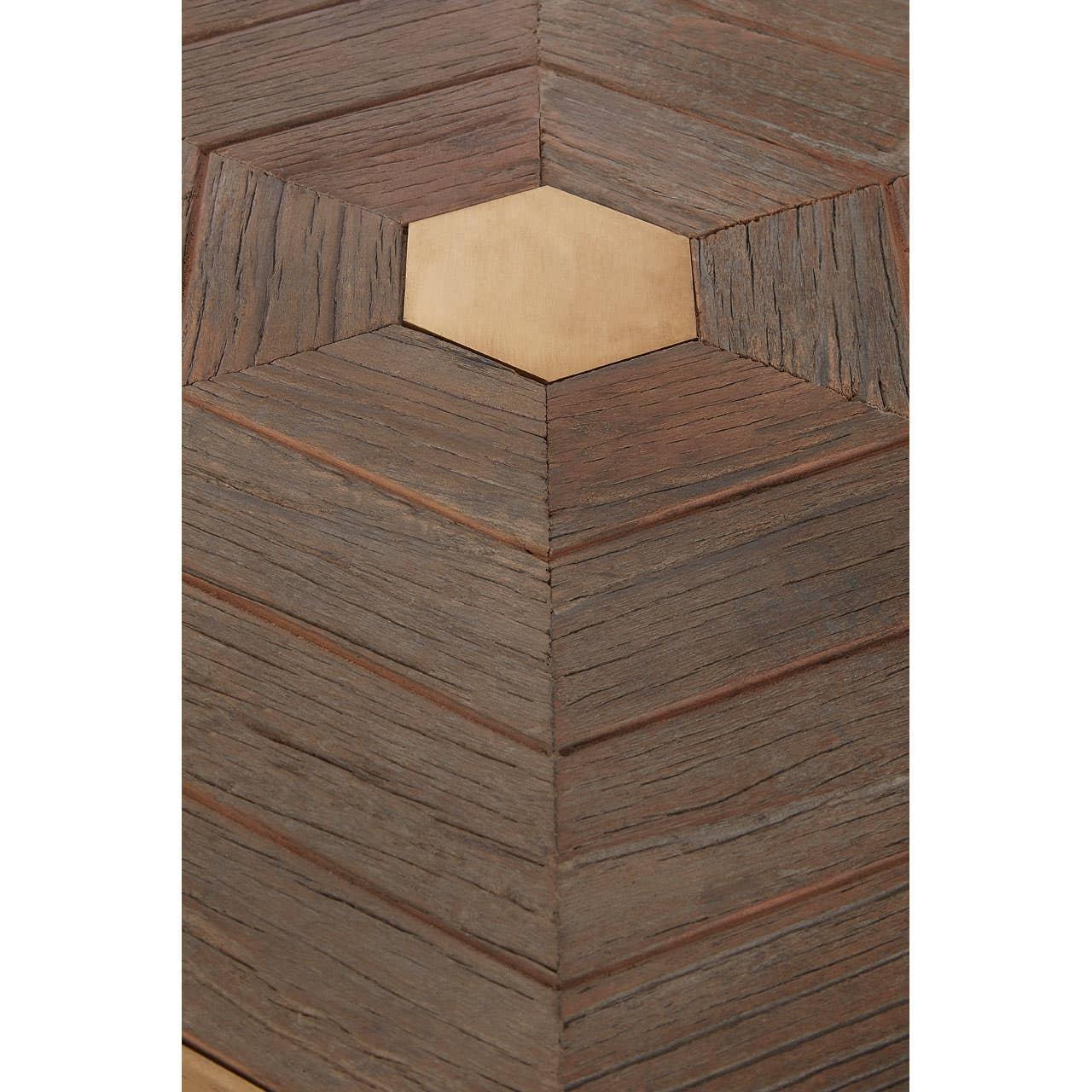 Wooden table surface with geometric chevron pattern and central hexagonal inlay detail