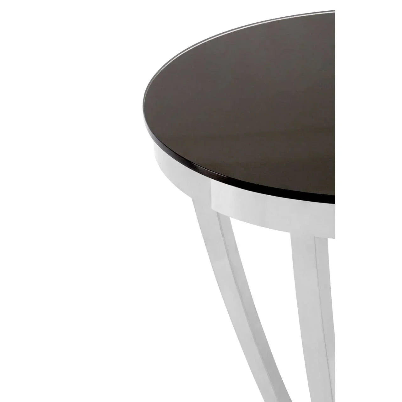 Round glass top side table with chrome metal legs, close-up of corner detail