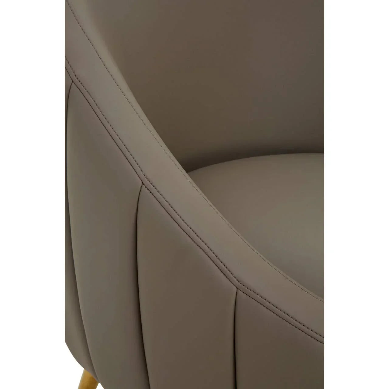 Close-up of taupe faux leather armchair with curved backrest and stitched detailing