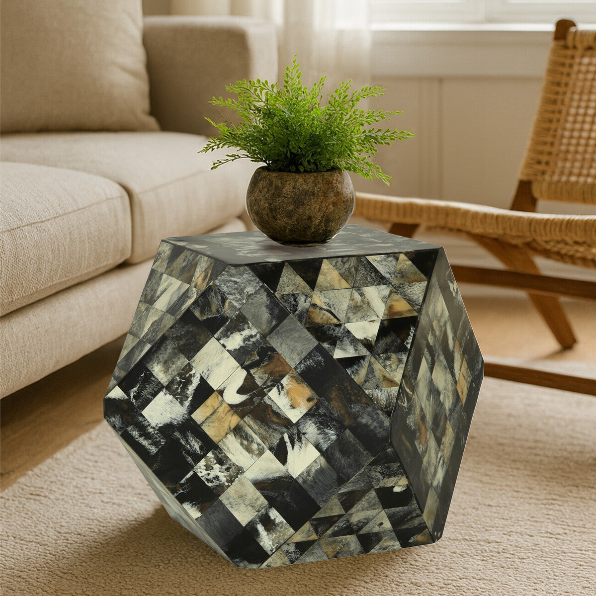 Antique green mosaic geometric hexagon side table featuring a multi-colored mosaic pattern with gold and silver accents, topped with a small potted plant. The table is positioned next to a light-colored sofa and a wooden rocking chair, set on a beige carpet. Natural light filters through a nearby window, illuminating the scene