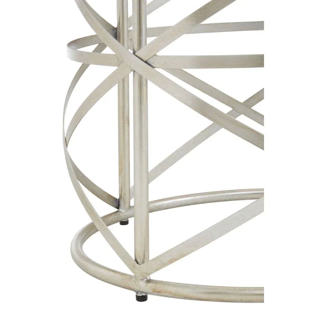 Silver metal table base with intersecting circular bars, close-up furniture detail