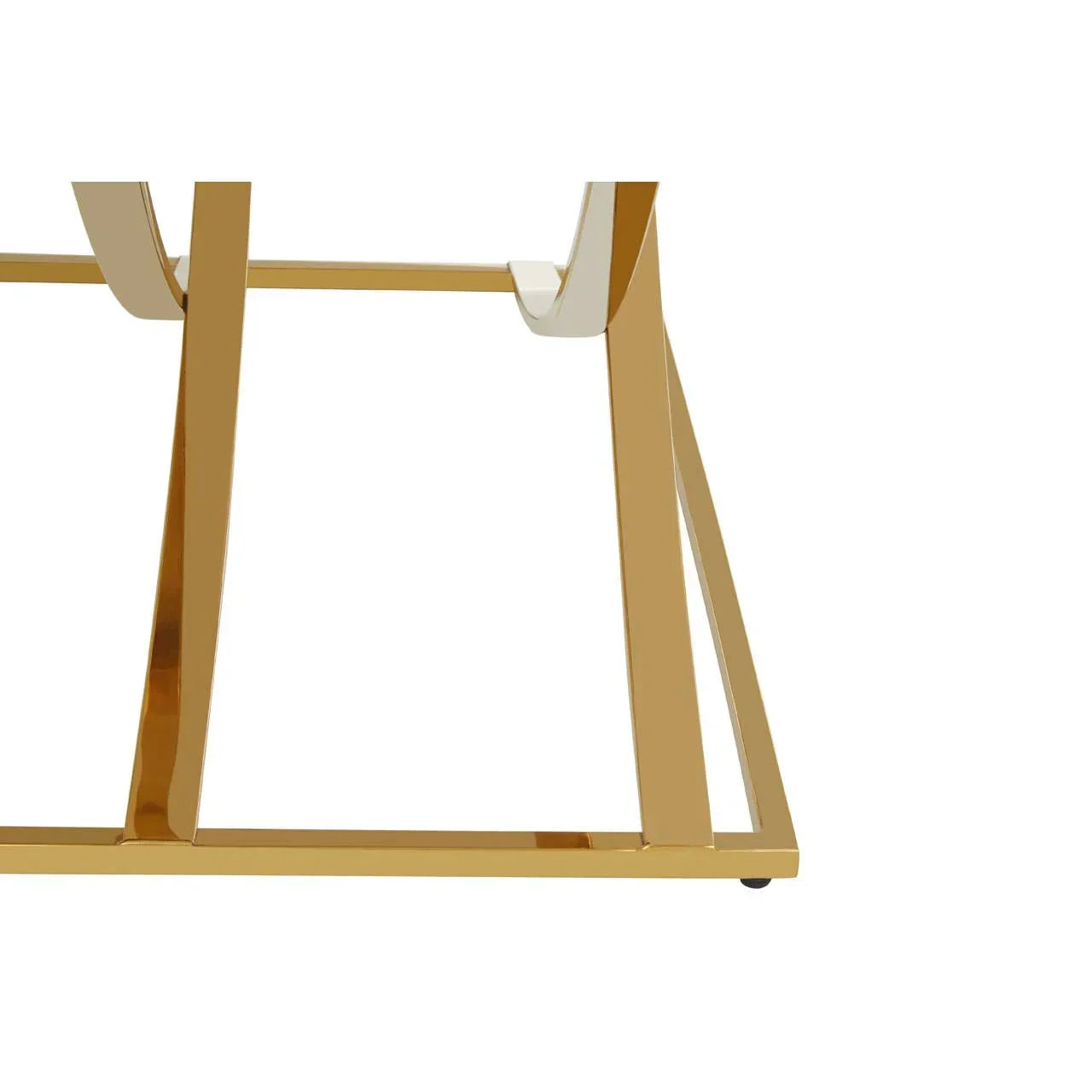 Gold metal table base with geometric lines and glossy finish, close-up view