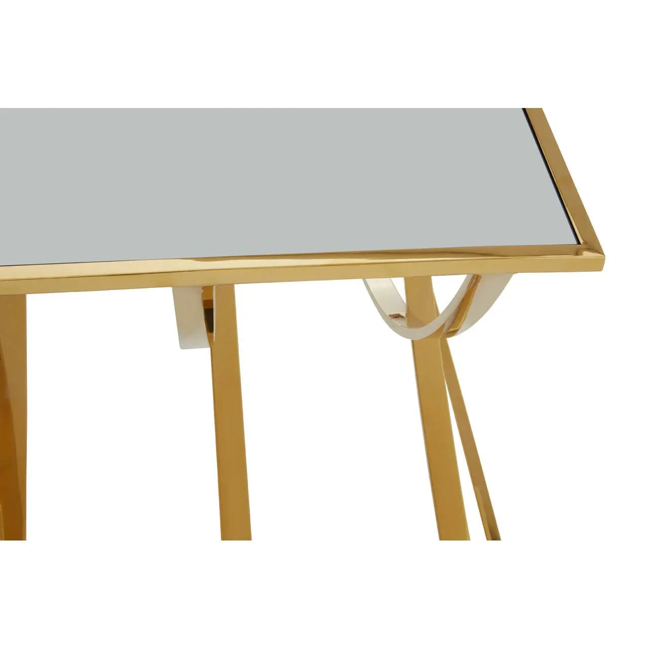 Glass top coffee table with gold metal frame, close-up of corner and leg design