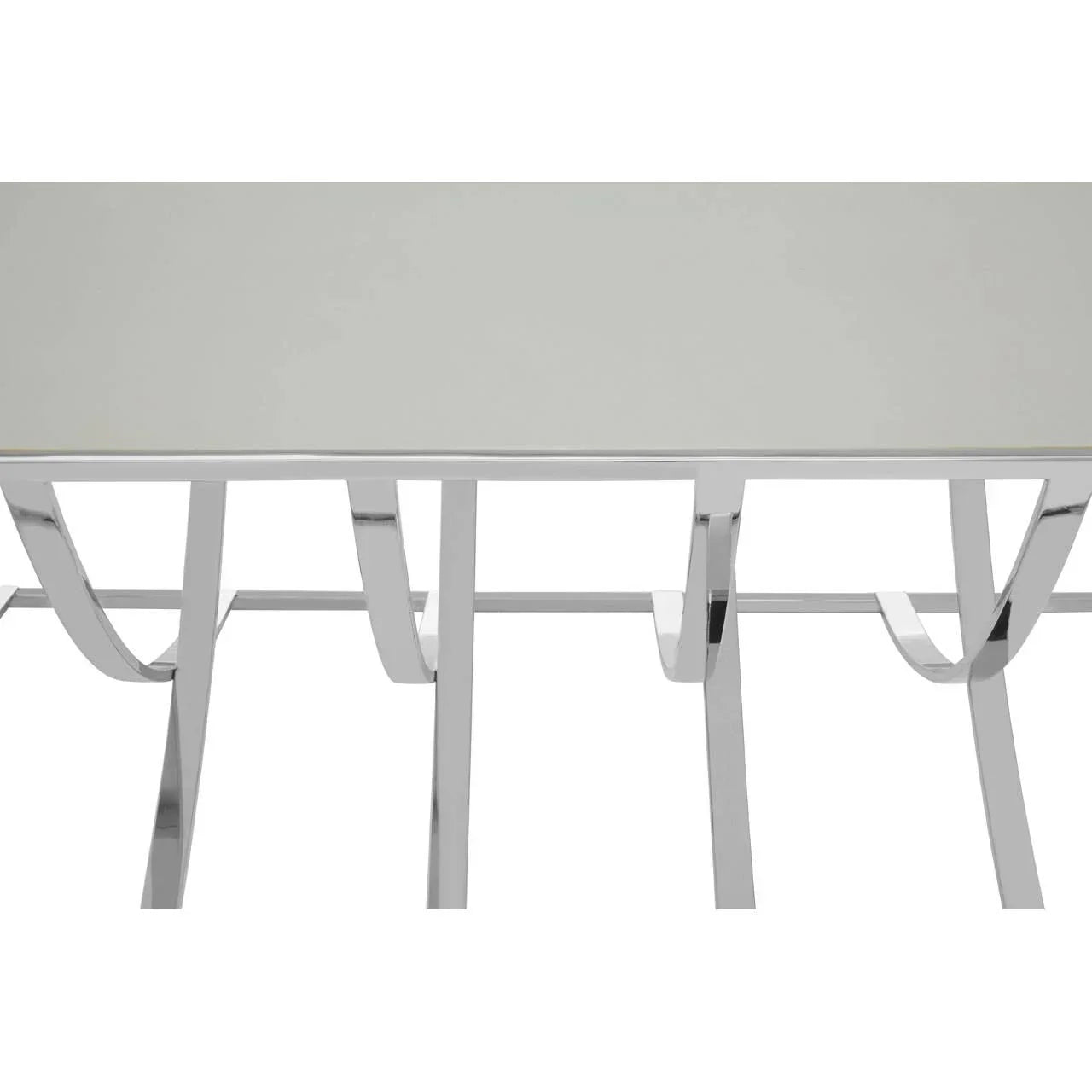 Modern glass dining table with chrome curved metal legs, viewed from above and front angle