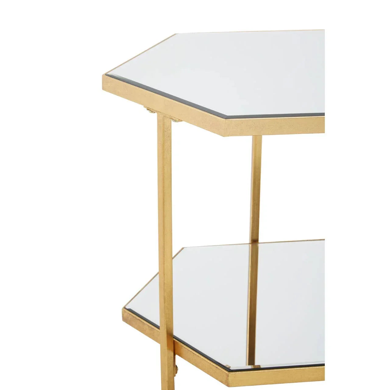 Gold metal side table with two hexagon mirrored shelves, close-up of corner