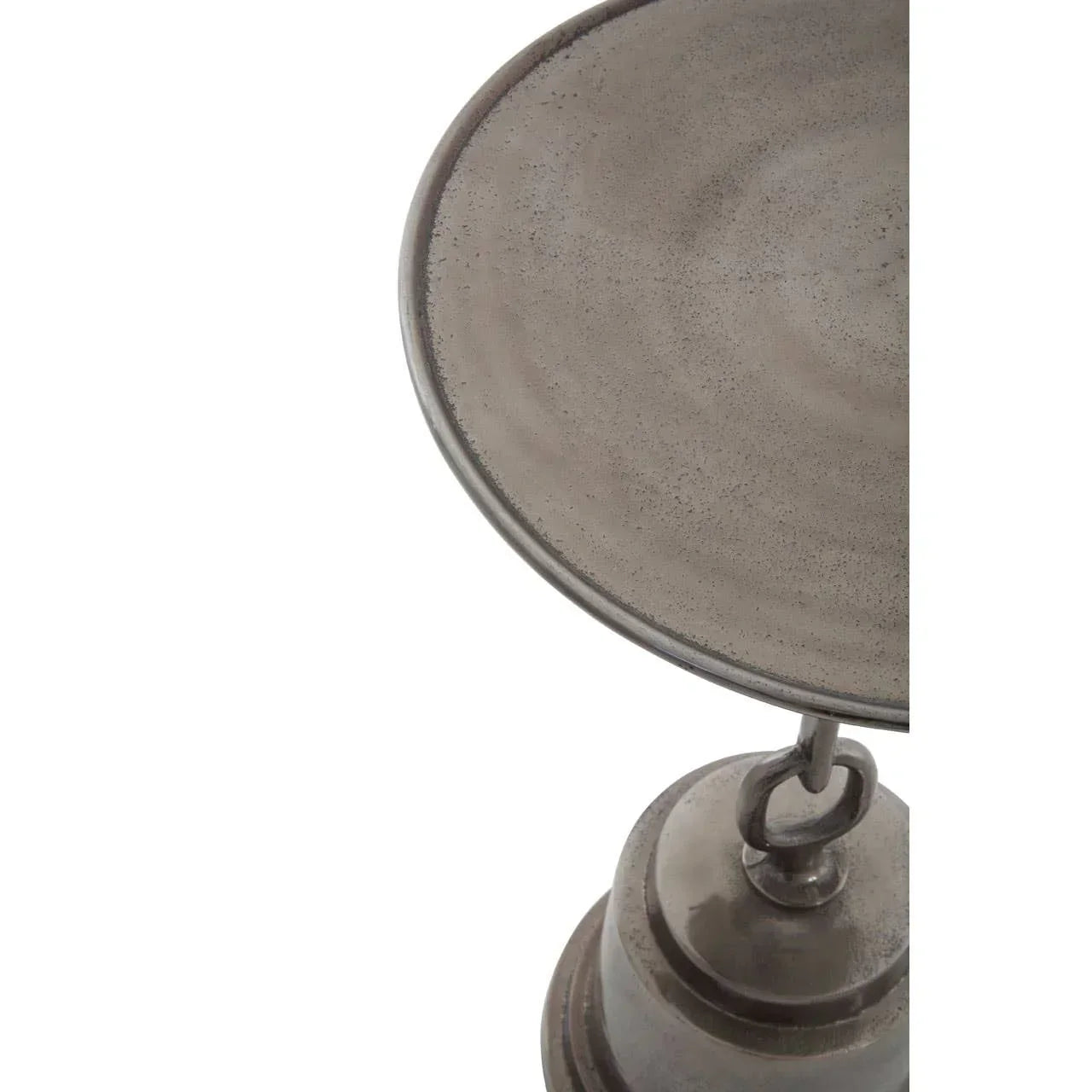 Close-up of round metal side table top with distressed grey finish