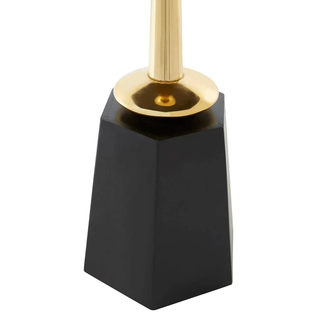 Close-up of gold and black candlestick holder with geometric base