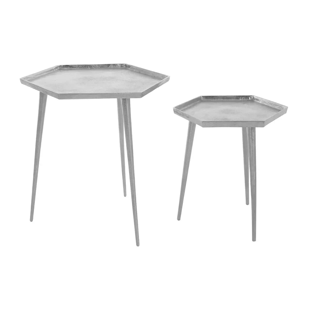 Set of two silver hexagonal metal side tables with slim legs on white background
