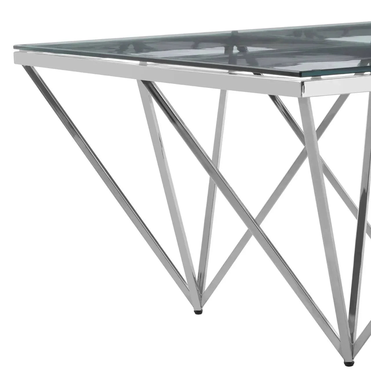 Glass dining table with chrome metal legs in geometric design, close-up side view