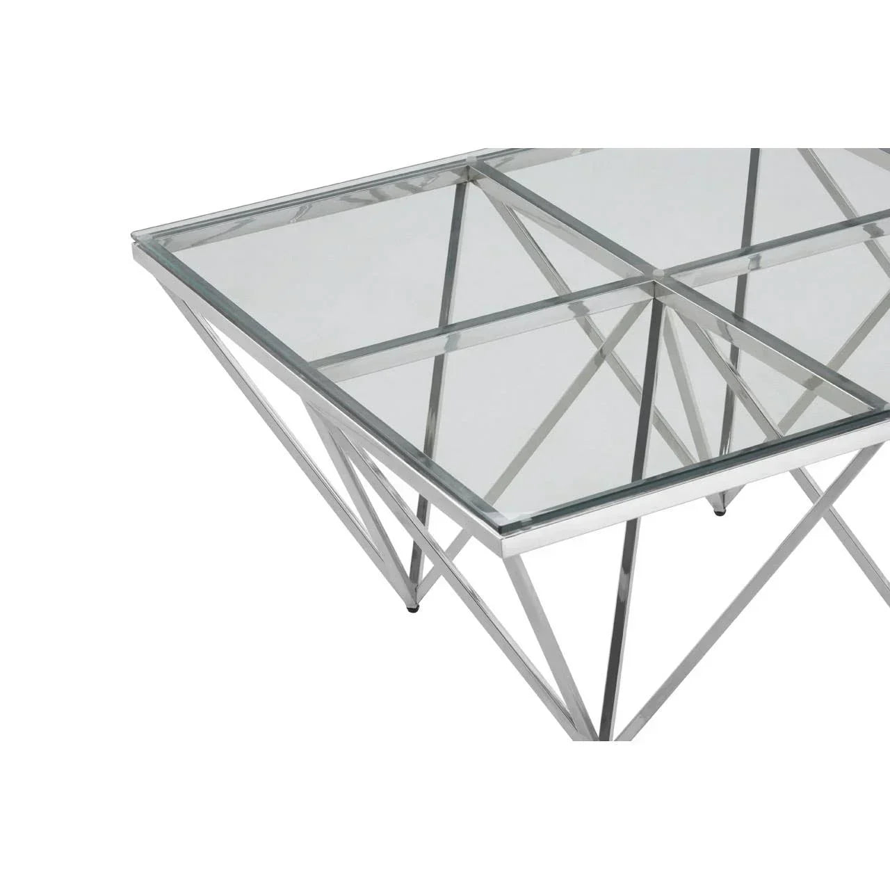Glass coffee table with chrome metal frame and geometric legs, close-up corner view