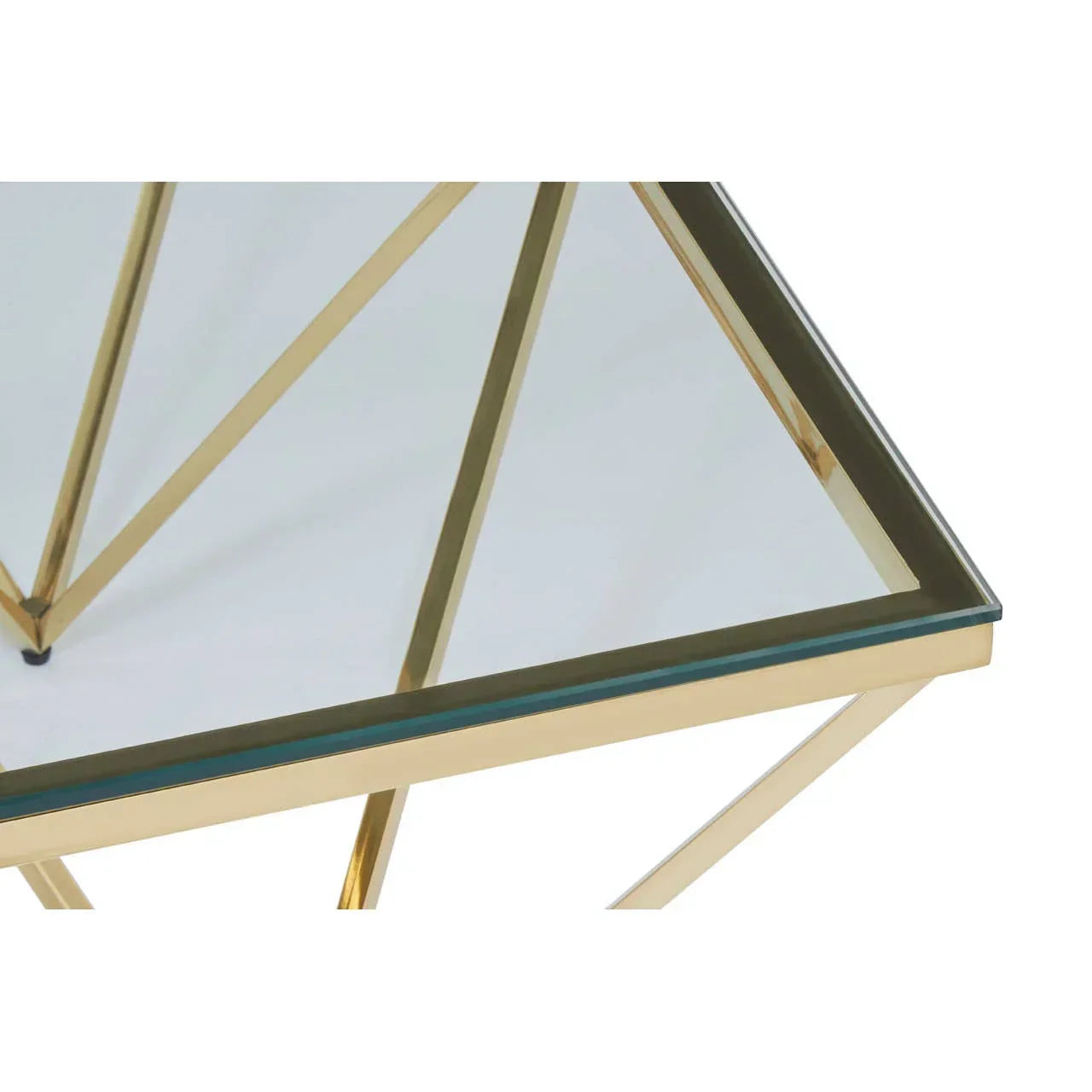 Glass coffee table with gold metal frame and geometric leg design close-up