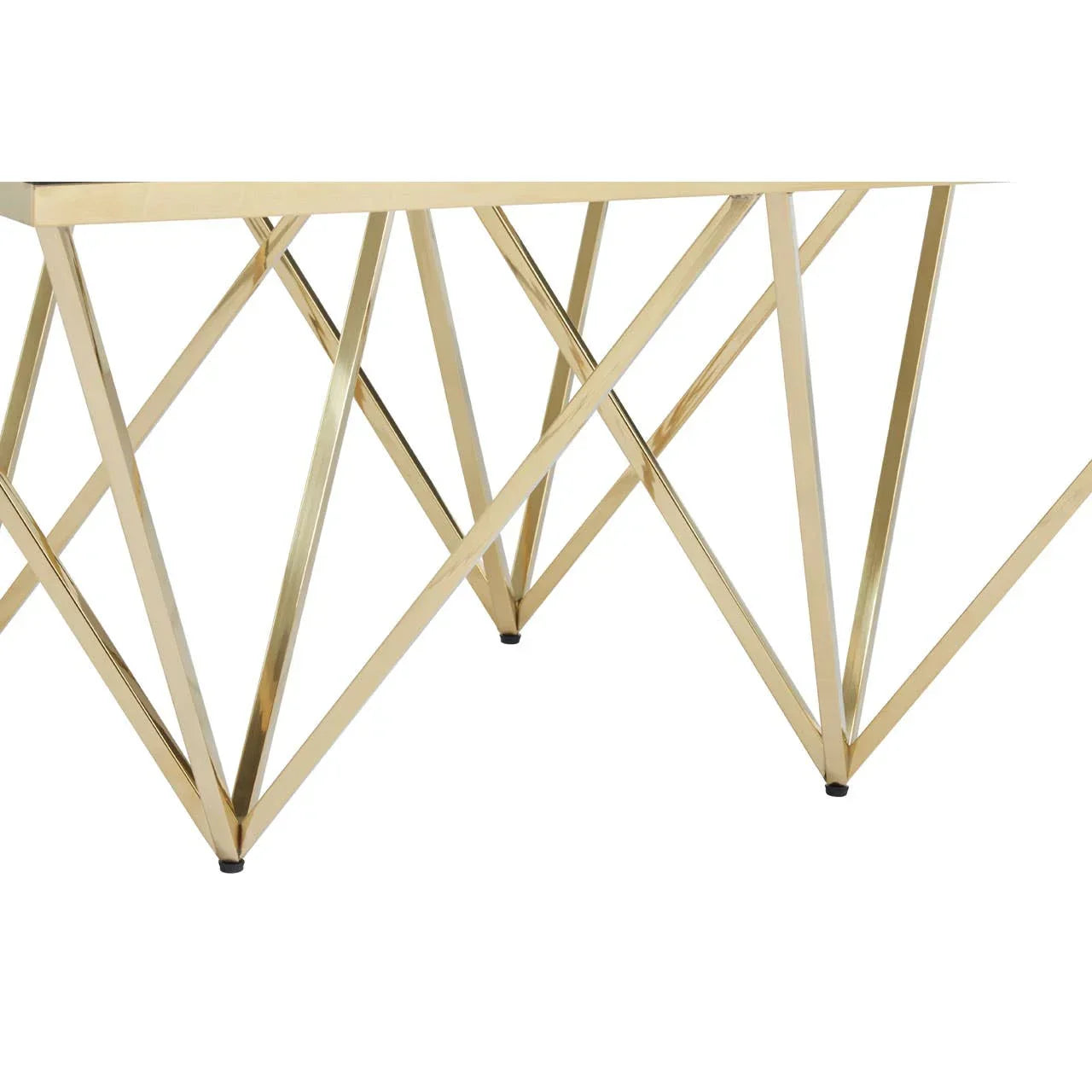 Gold metal console table with geometric base on white background