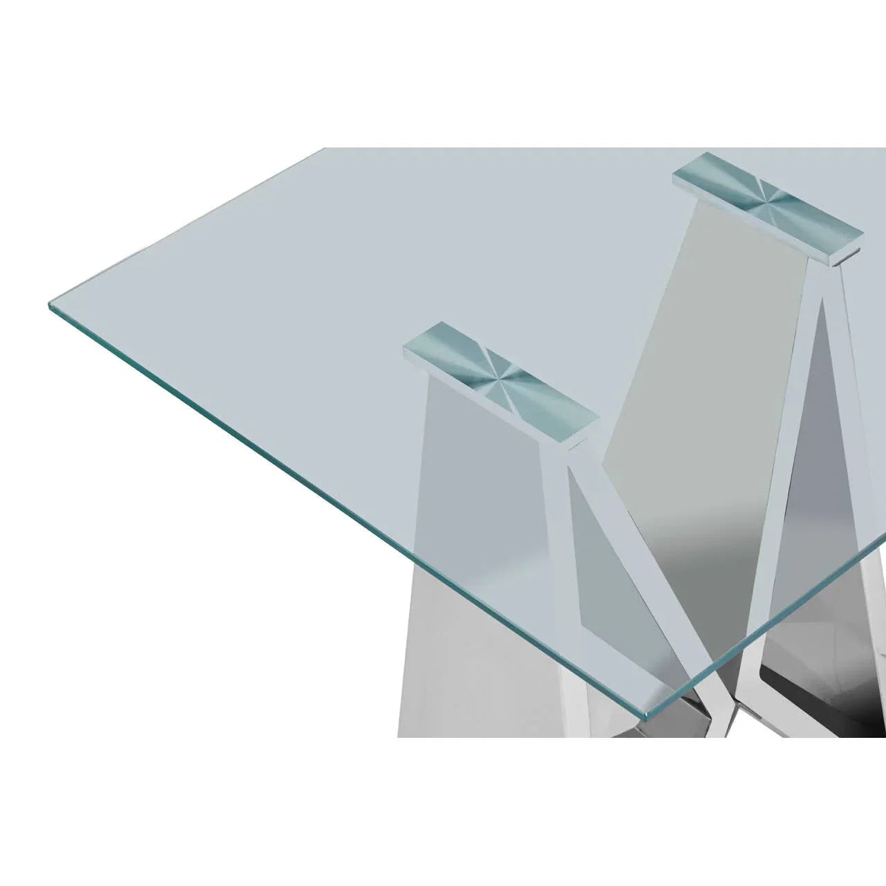 Clear glass dining table top with chrome geometric metal legs, corner close-up view