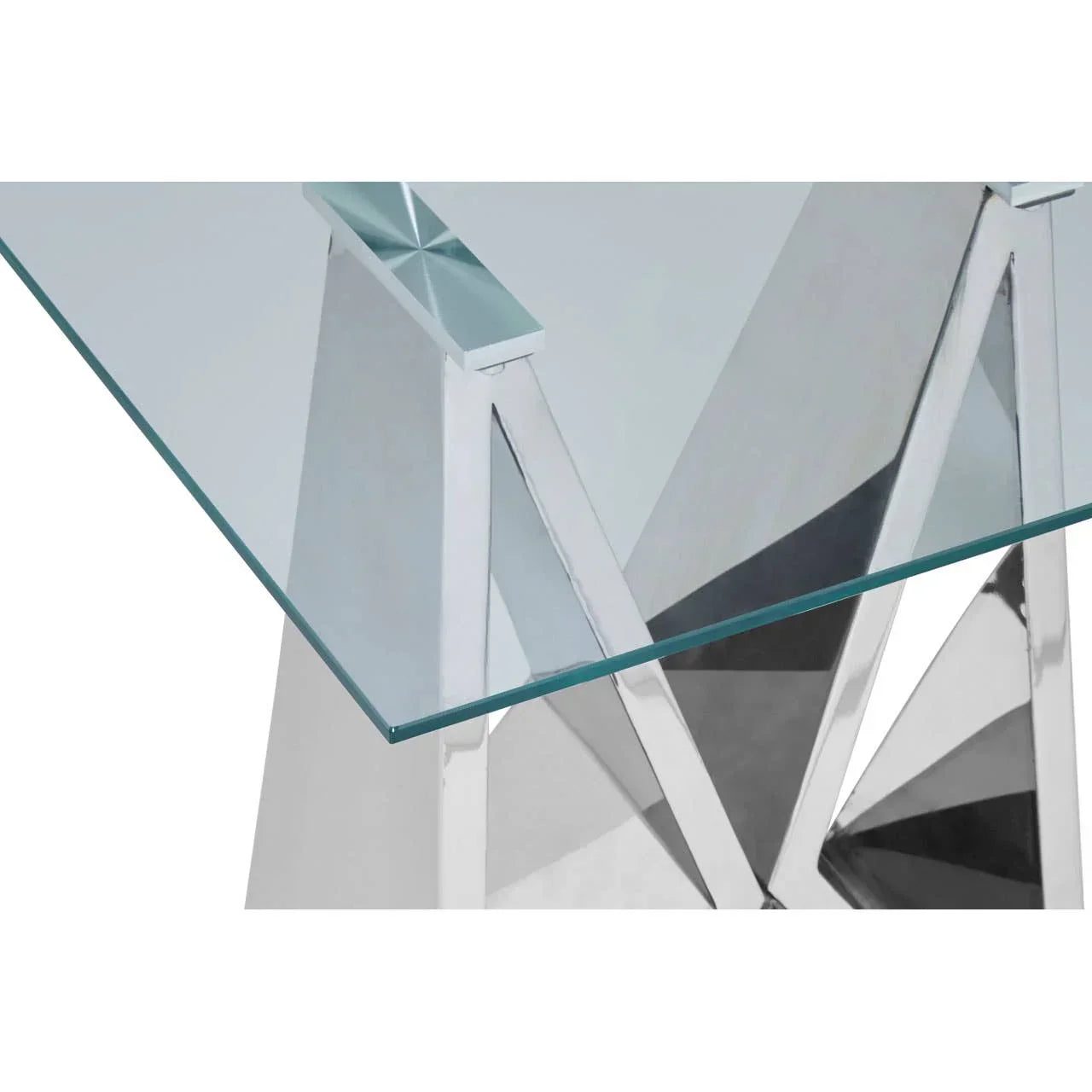 Modern glass dining table with geometric chrome legs, close-up of corner and base design
