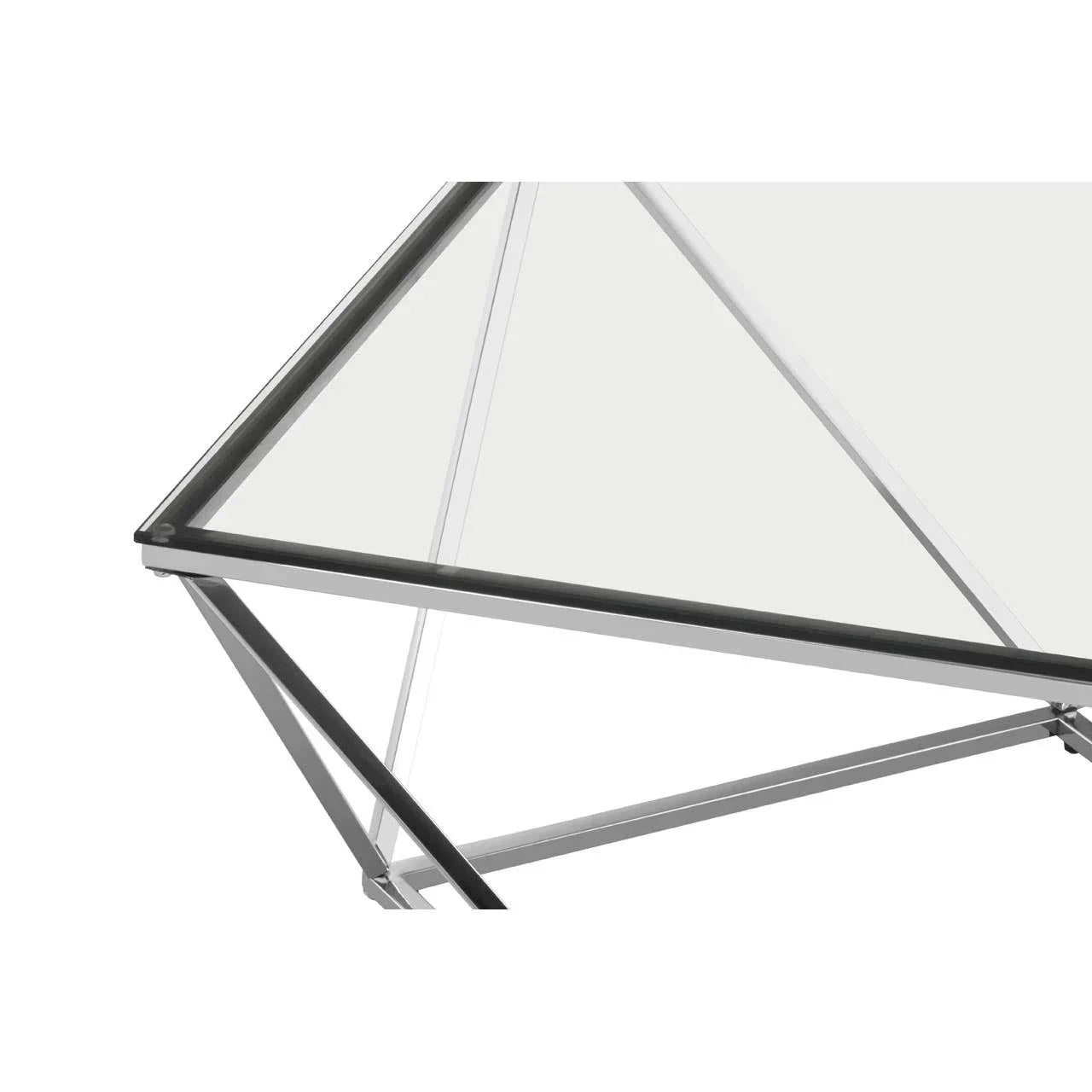 Glass top dining table with black metal frame and geometric legs, close-up view