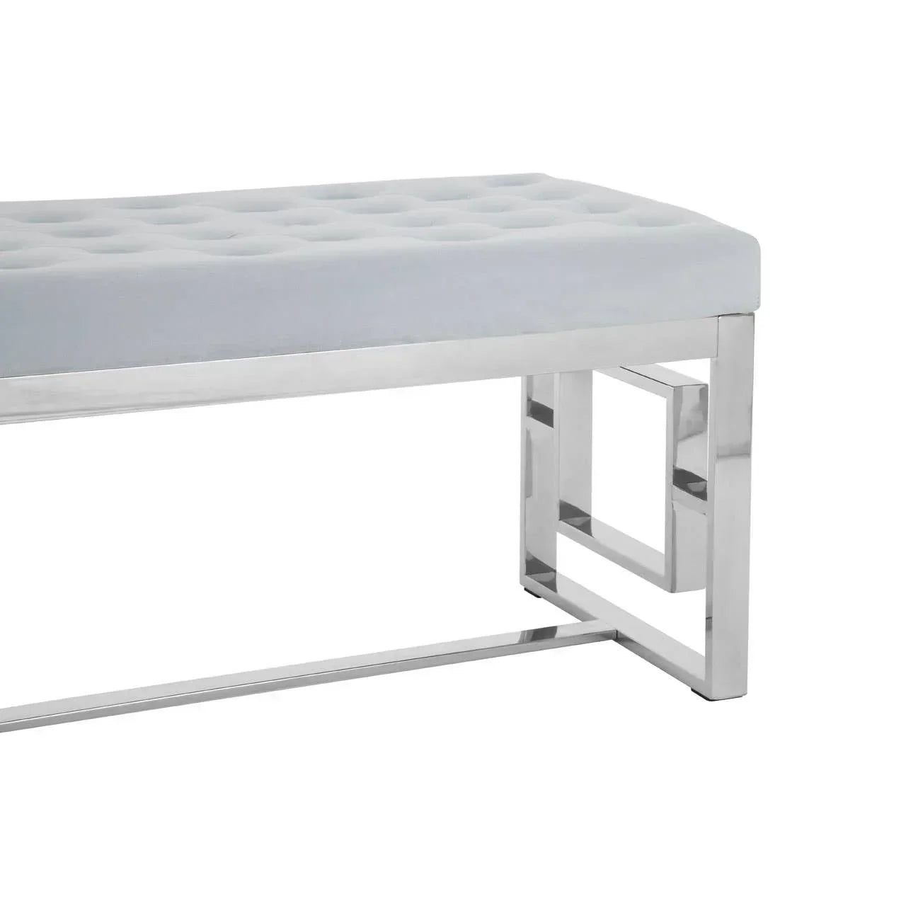 Grey velvet bench with tufted seat and chrome metal legs, side angle view