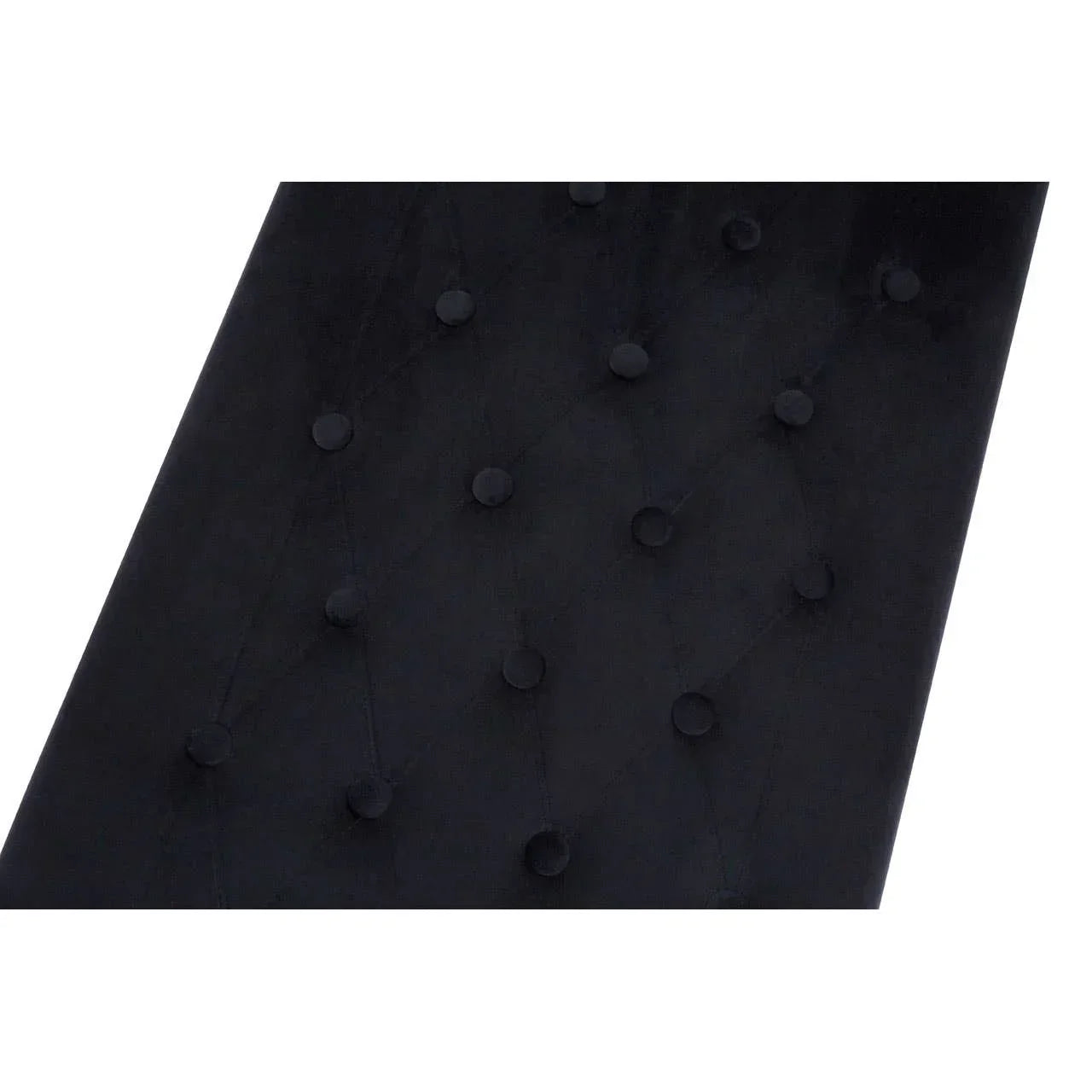 Black velvet headboard with button tufted detail in close-up view