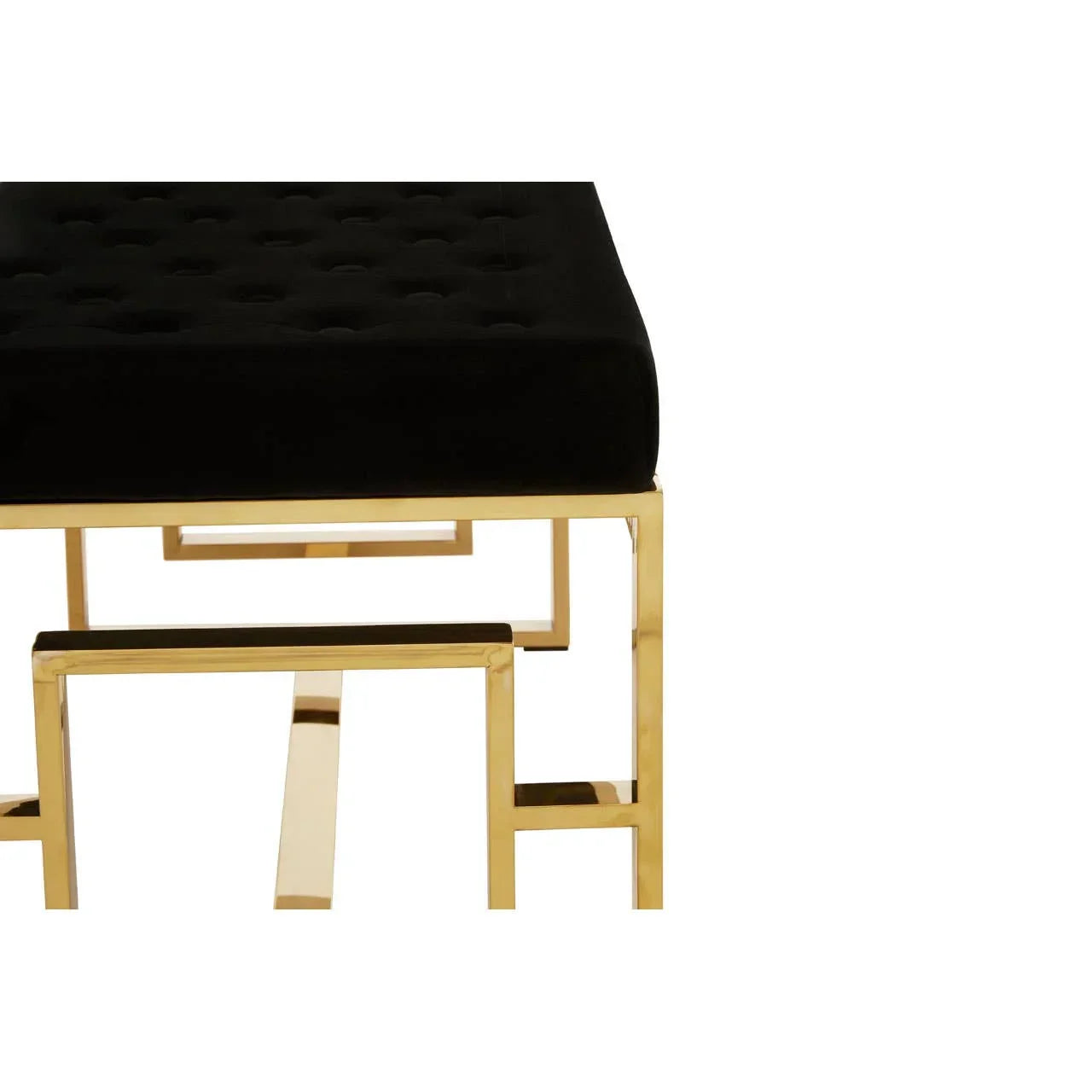 Black upholstered bench with gold metal frame, close-up on seat and geometric legs