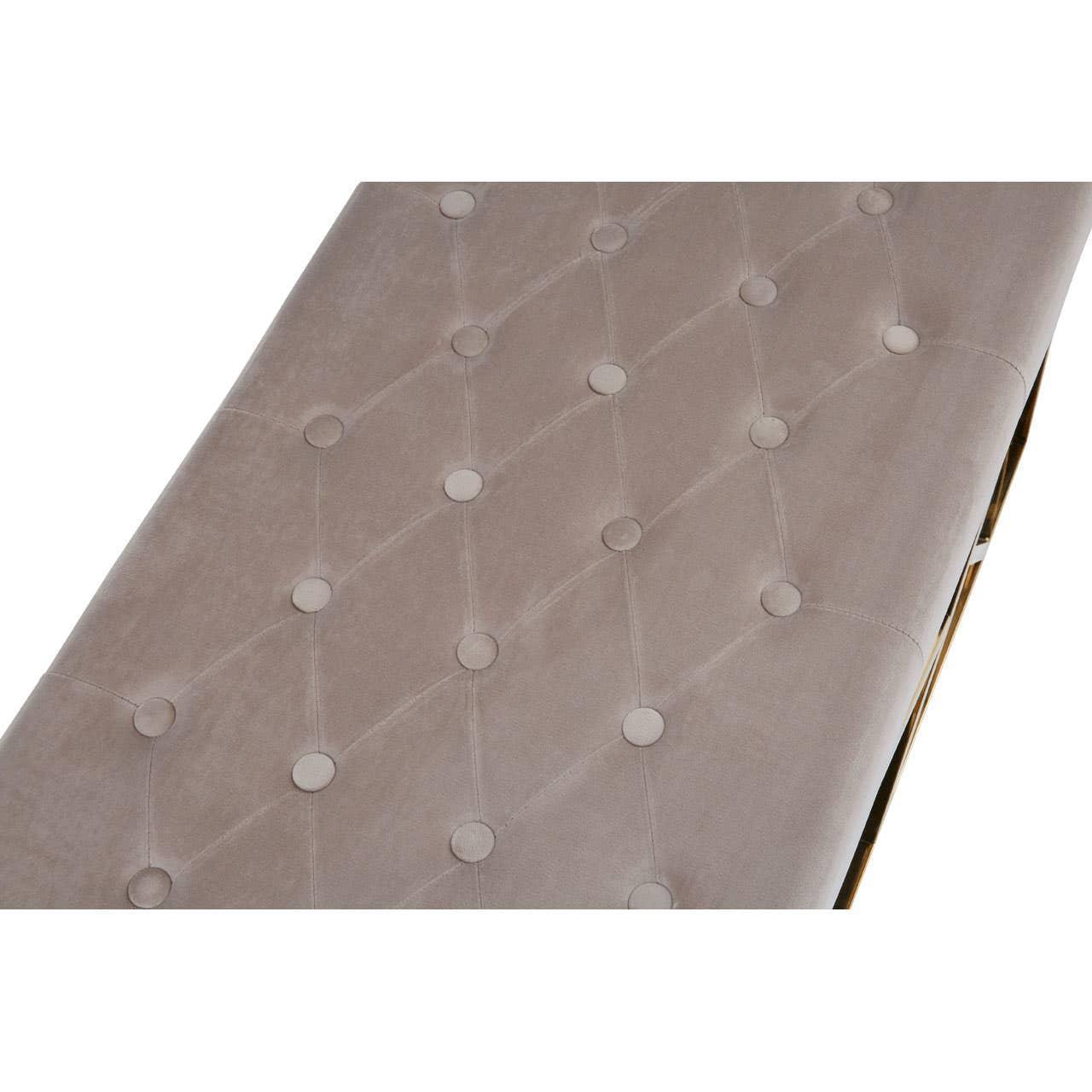 Close up of beige velvet sofa with diamond button tufted upholstery