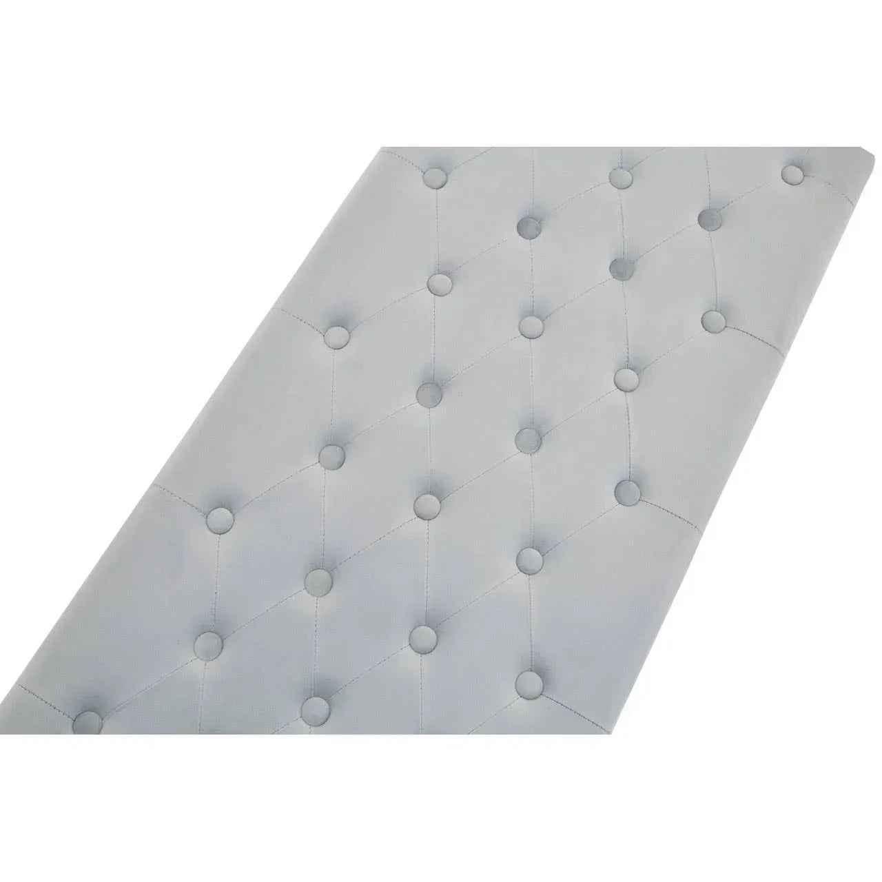 Closeup of grey tufted upholstered headboard with button detail