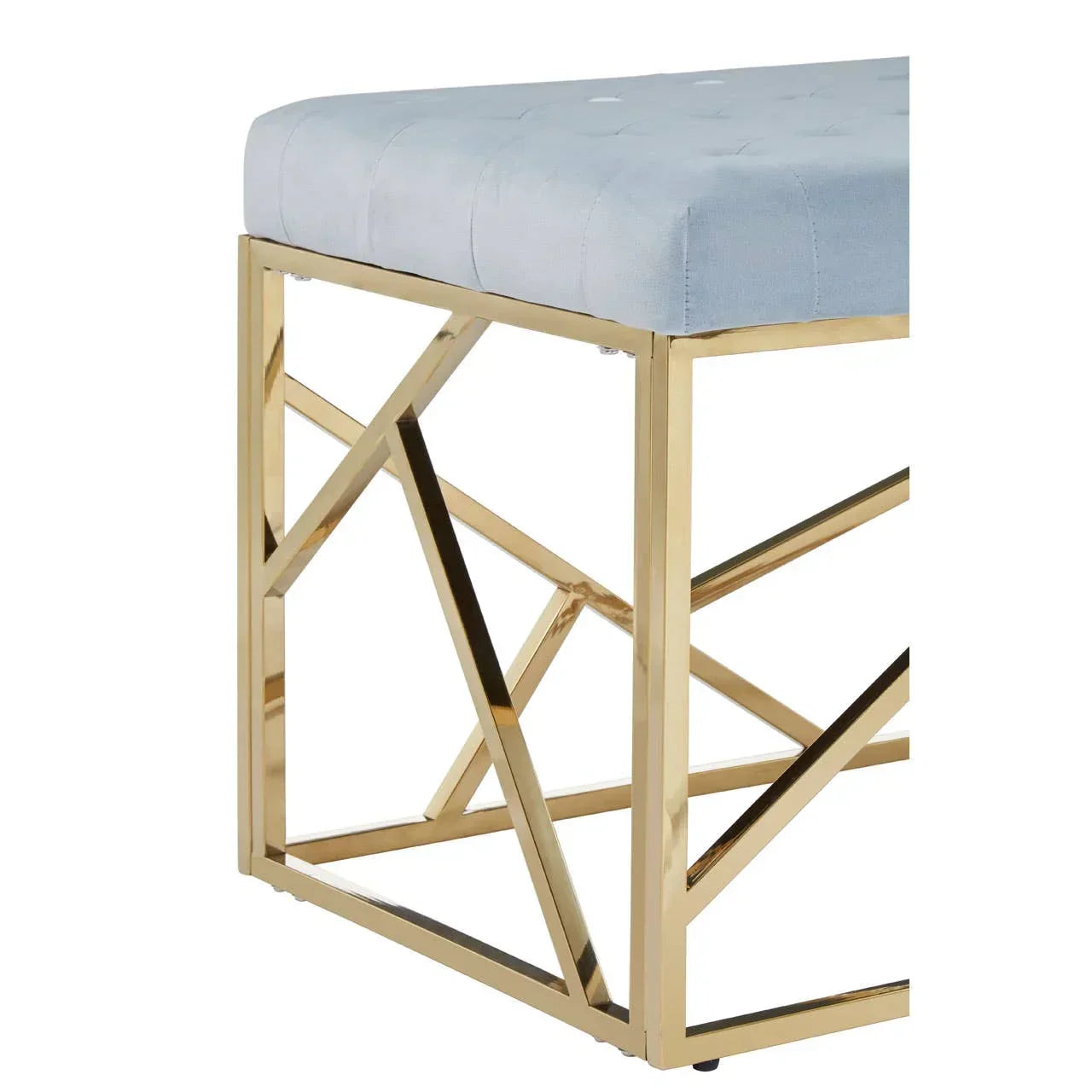Velvet bench with tufted light grey seat and gold geometric metal legs, corner view
