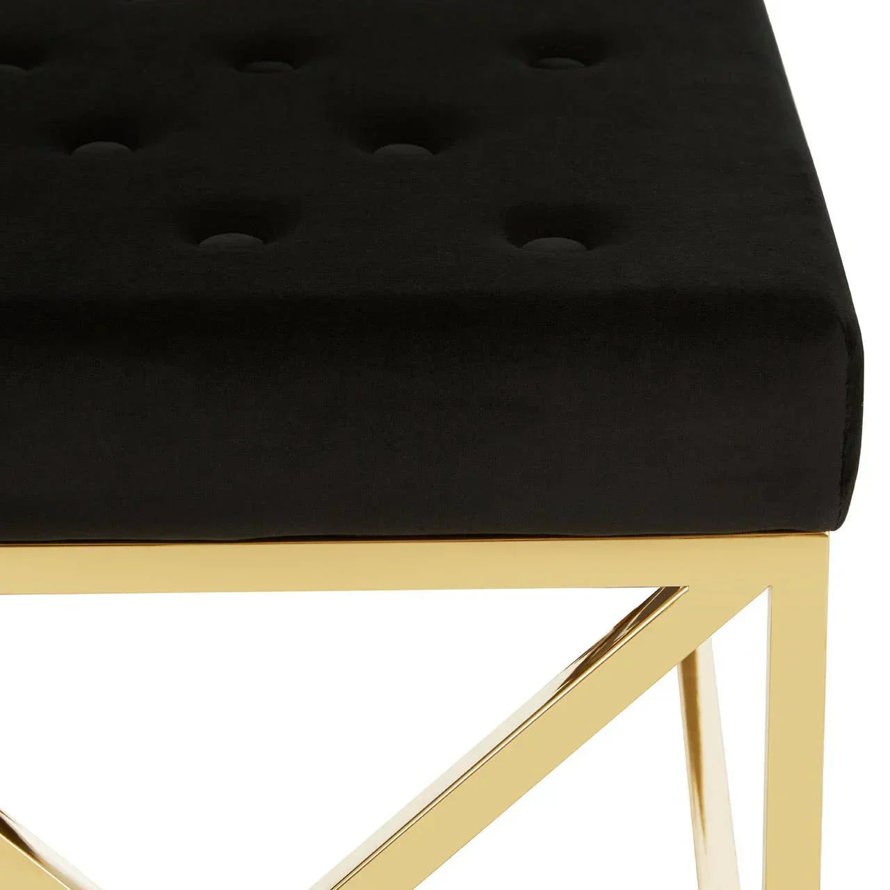 Black velvet bench seat with gold metal frame and geometric base detail