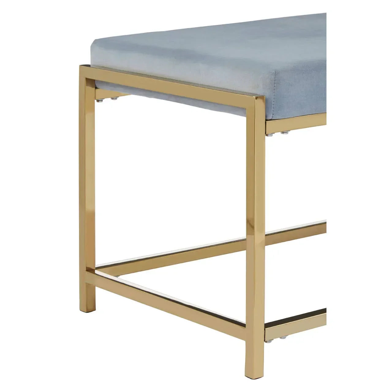 Close view of bench with gold metal frame and light grey upholstered seat