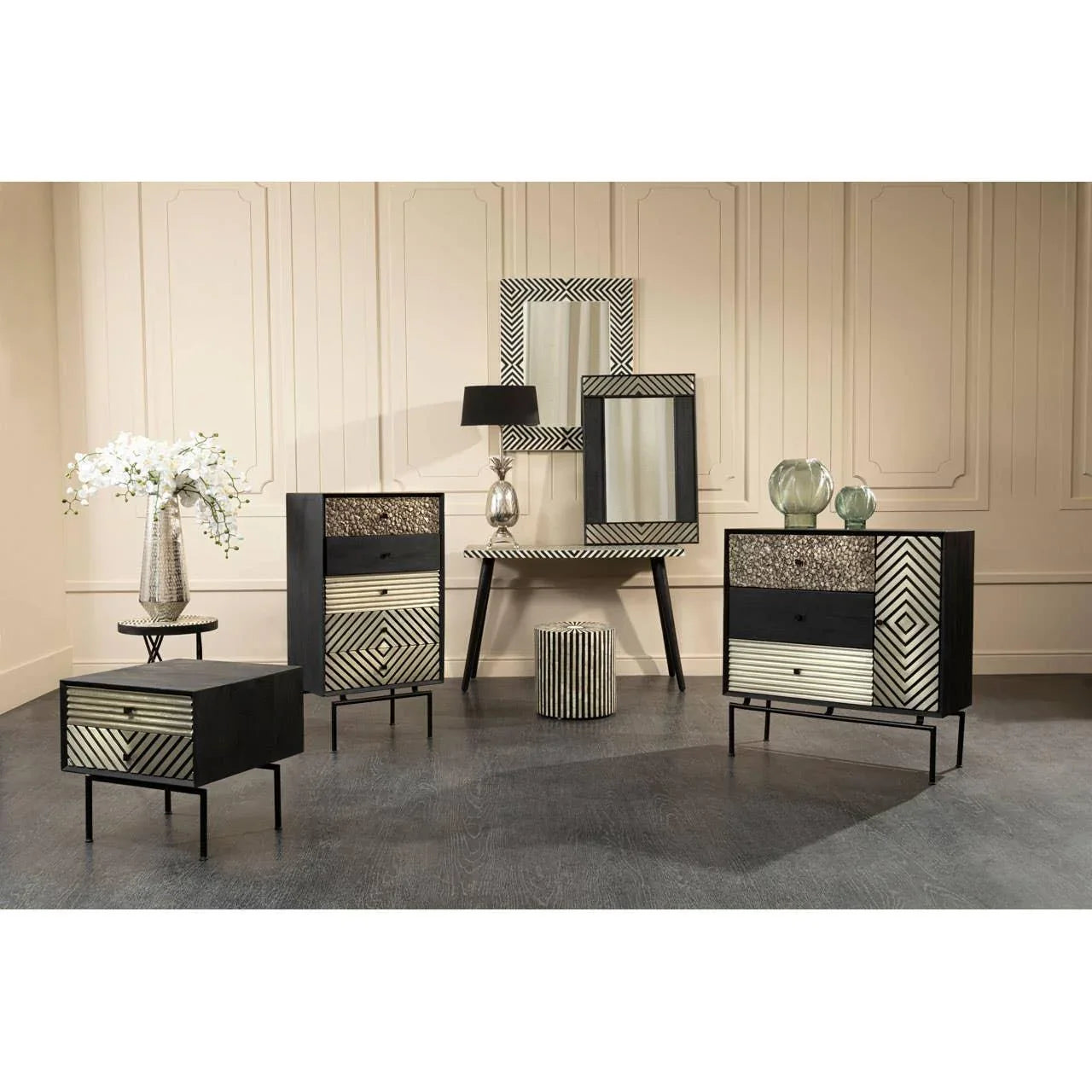 Modern black and gold patterned sideboard and drawers with matching mirrors and decor