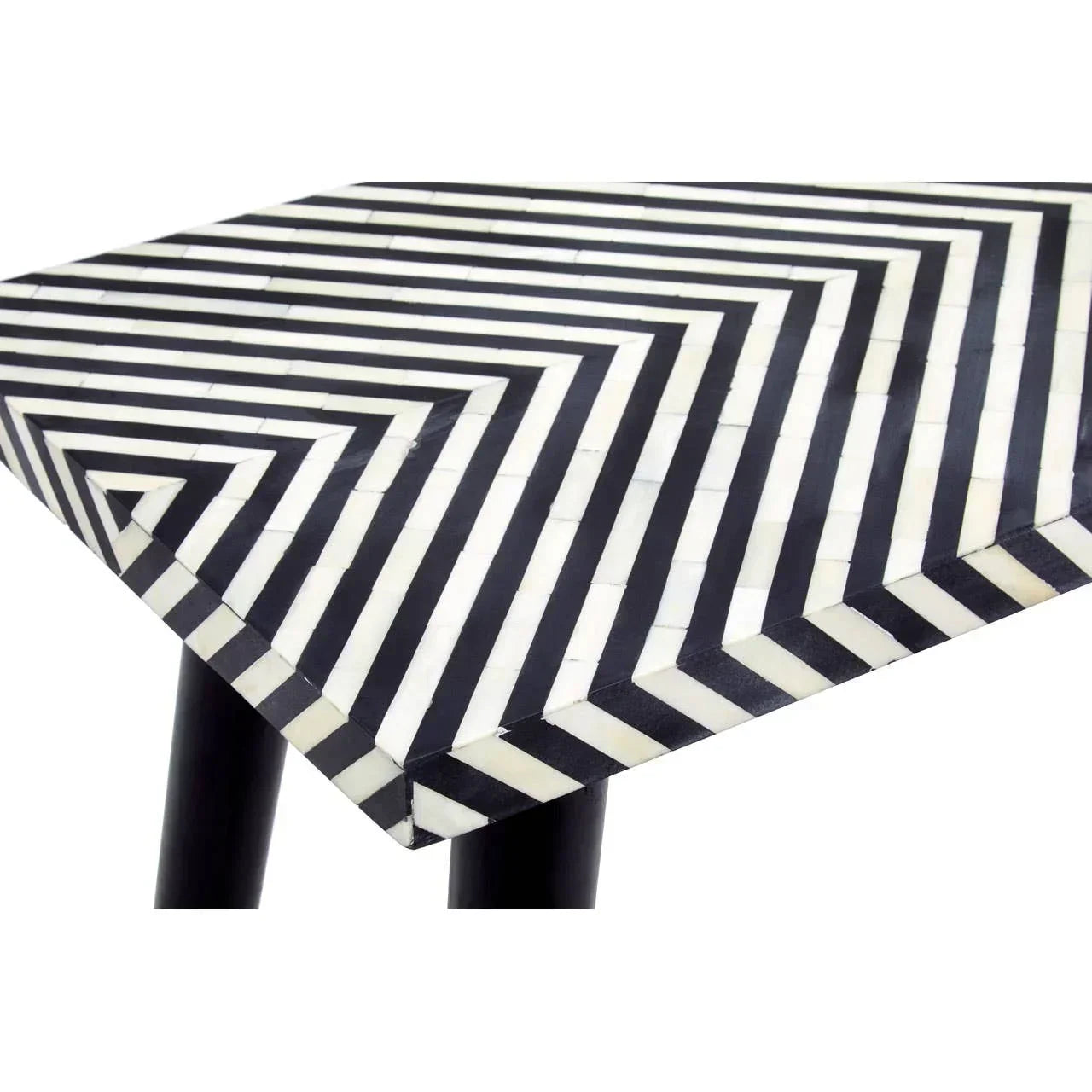 Black and white geometric patterned coffee table corner with tapered black legs