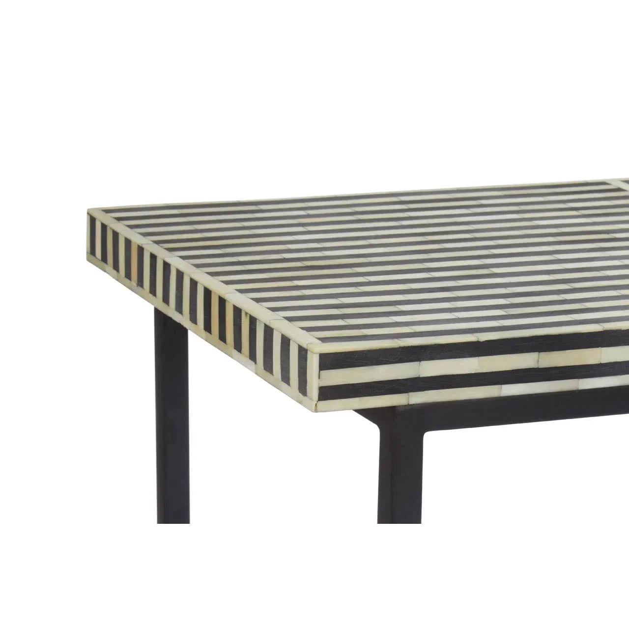Striped monochrome coffee table with black metal legs, close-up of patterned tabletop