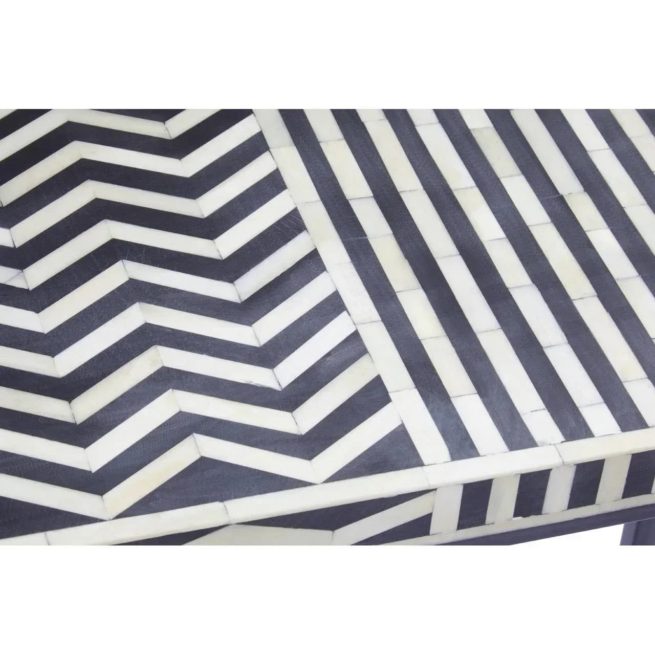 Chevron patterned dining table with black and white bone inlay close up