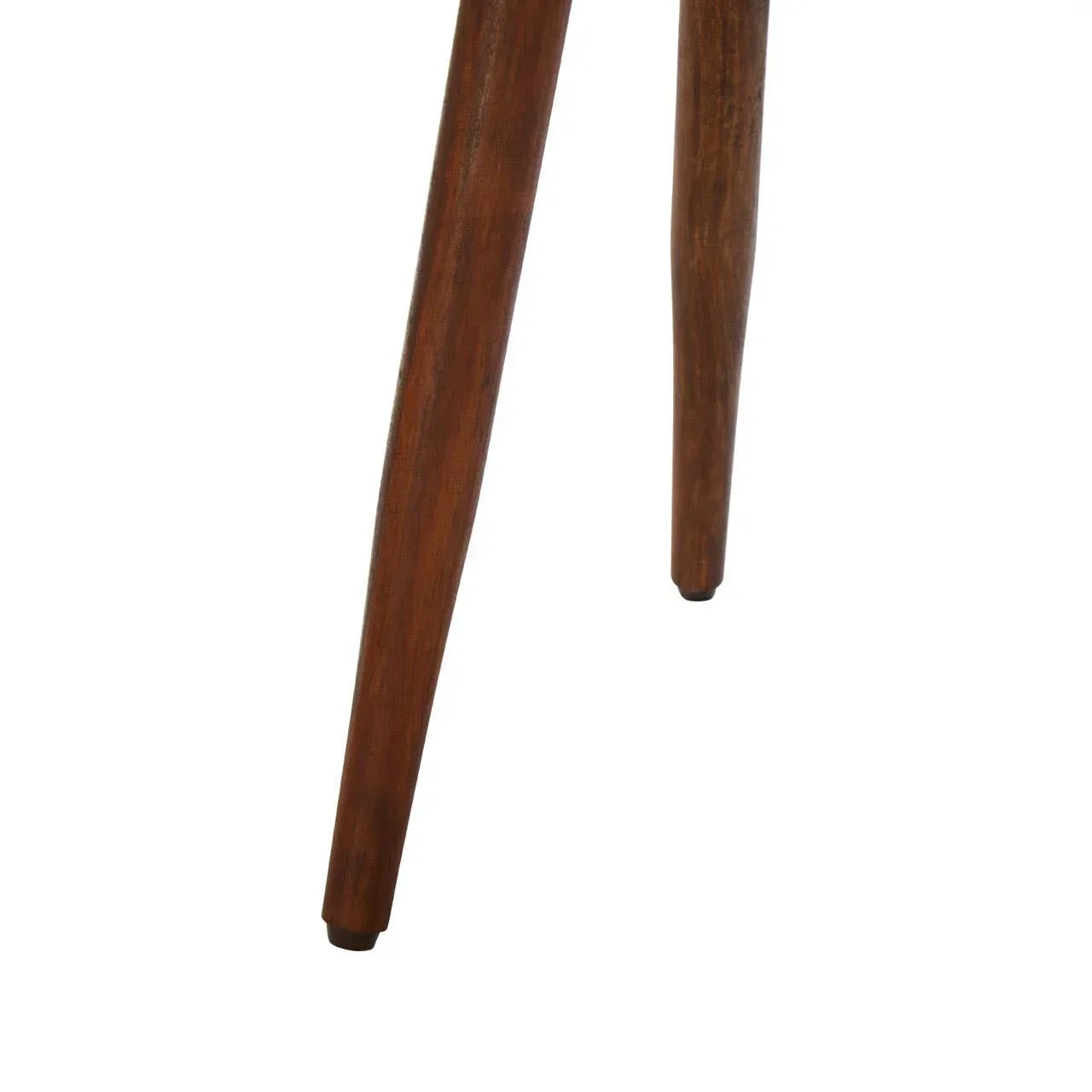 Closeup of angled wooden chair legs with walnut finish