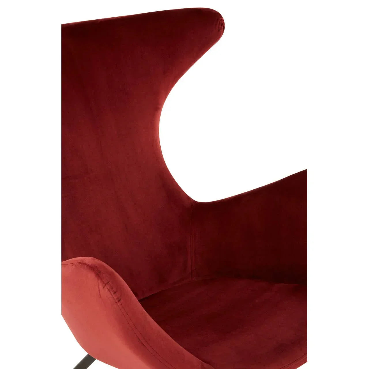 Close up of modern velvet accent chair with curved backrest in deep red upholstery