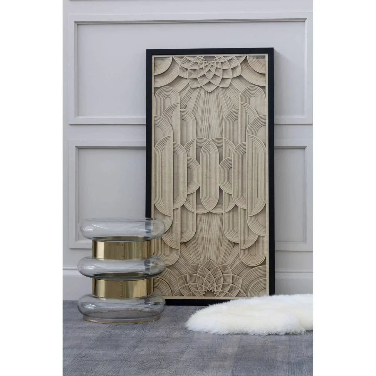 Geometric wall art with beige relief pattern, glass and gold accent table, faux fur rug