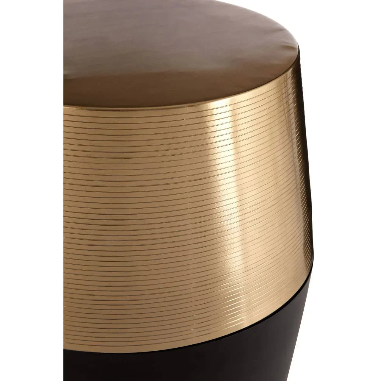 Round metallic gold side table with ribbed texture and matte black base, close-up view