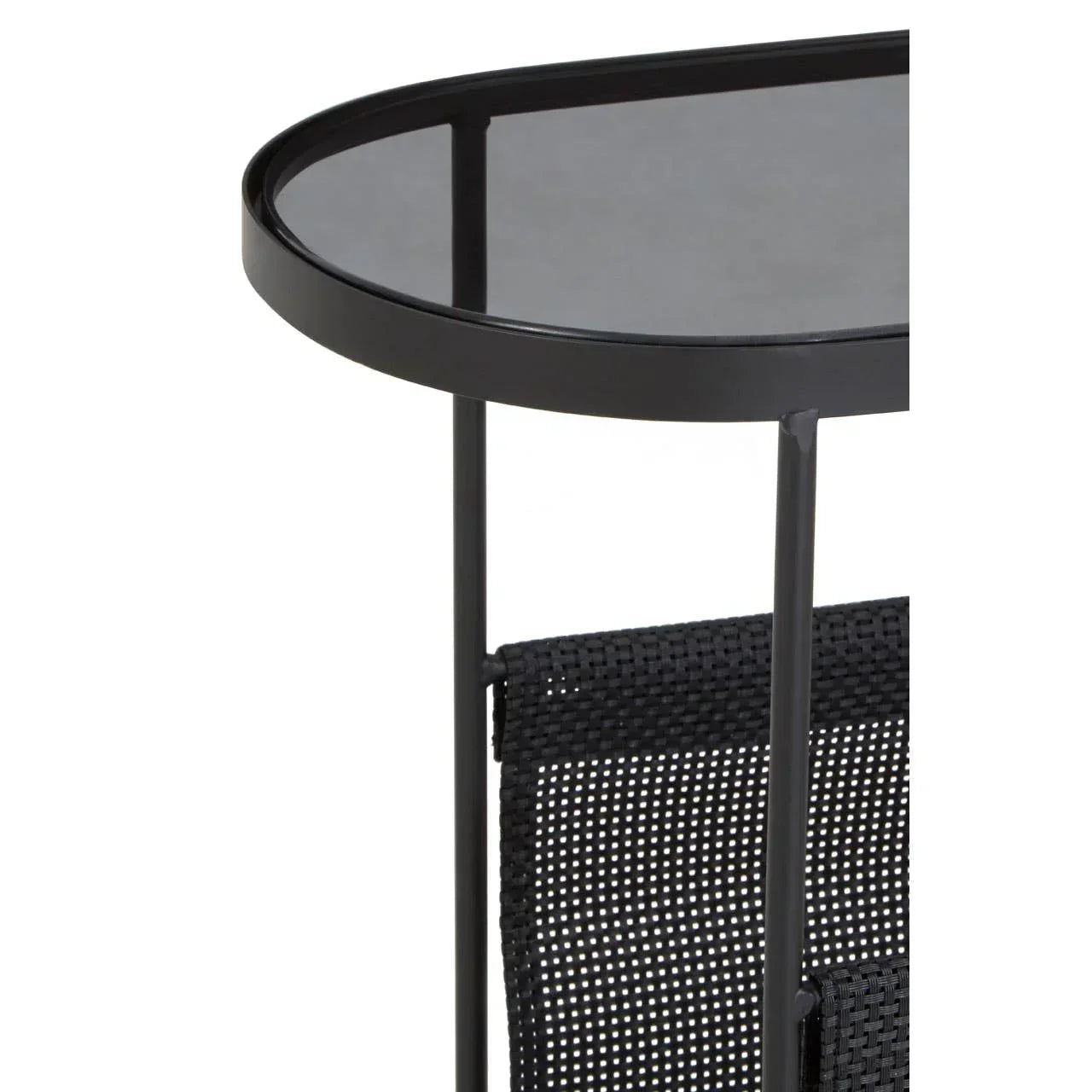 Black metal side table with smoked glass top and woven mesh shelf, close-up view