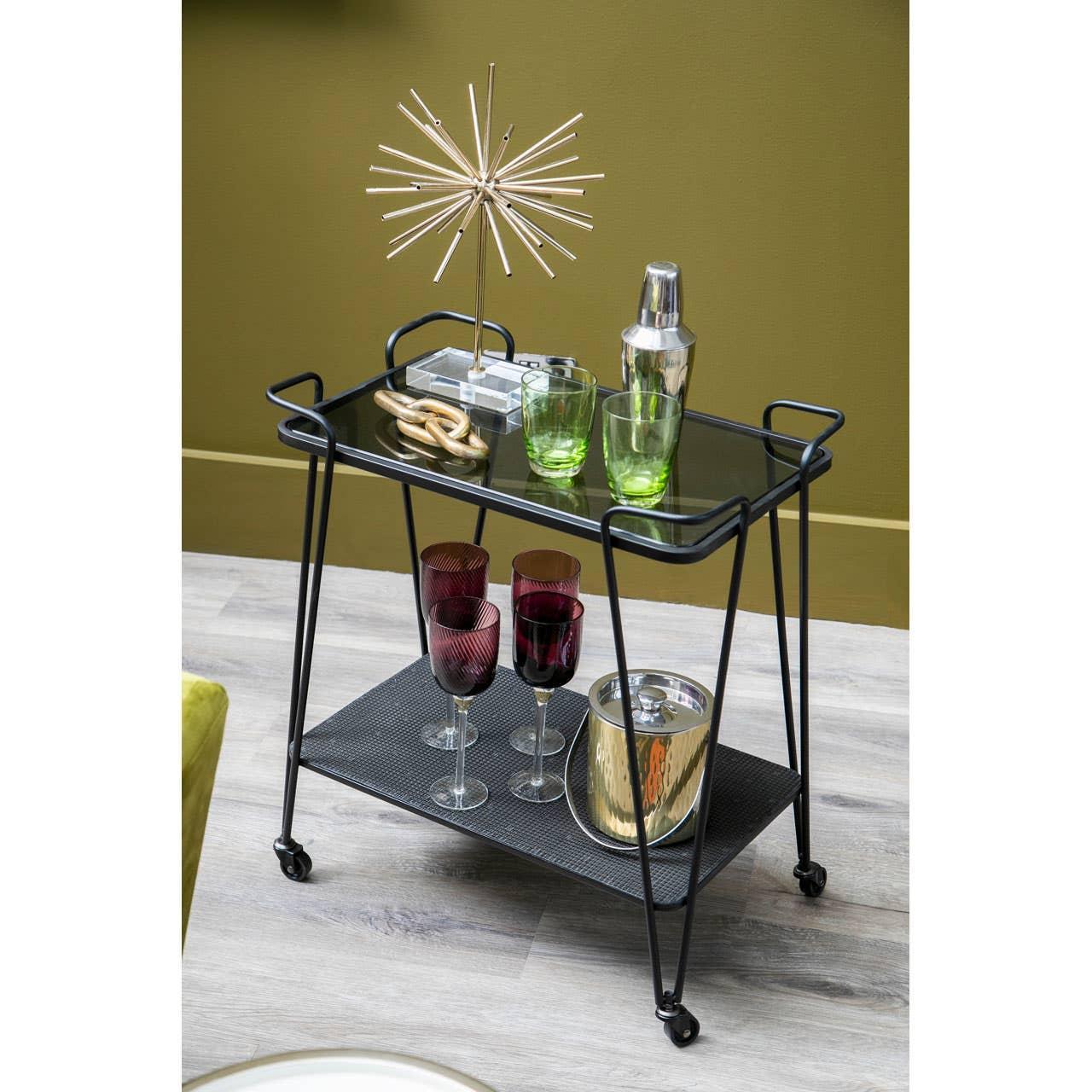 Black metal drinks trolley with glass top, green and purple glasses, gold ice bucket