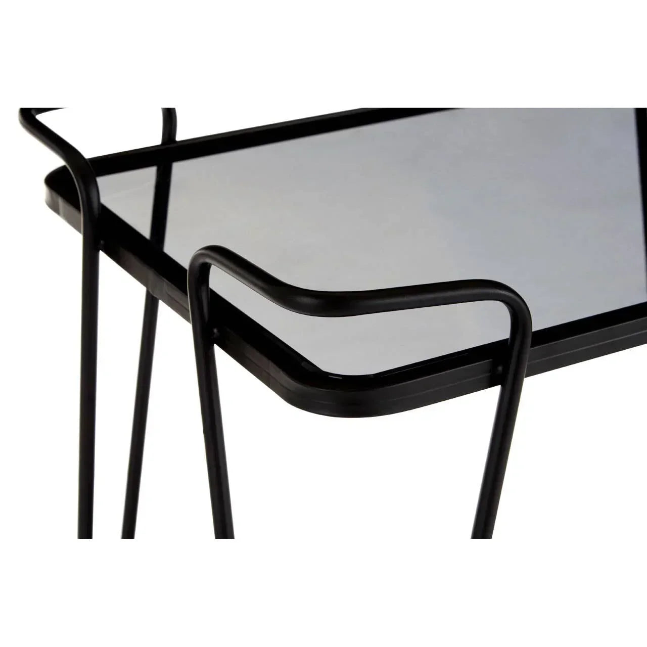Closeup of black metal side table with glass top and minimalist frame