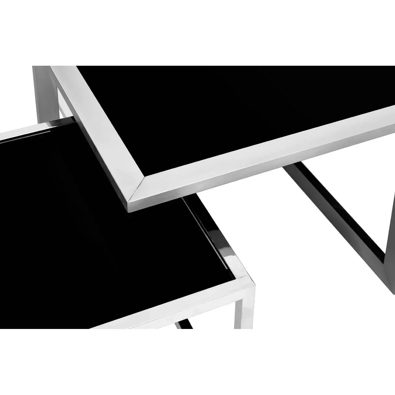 Black glass nesting tables with chrome metal frames, geometric design, close-up view