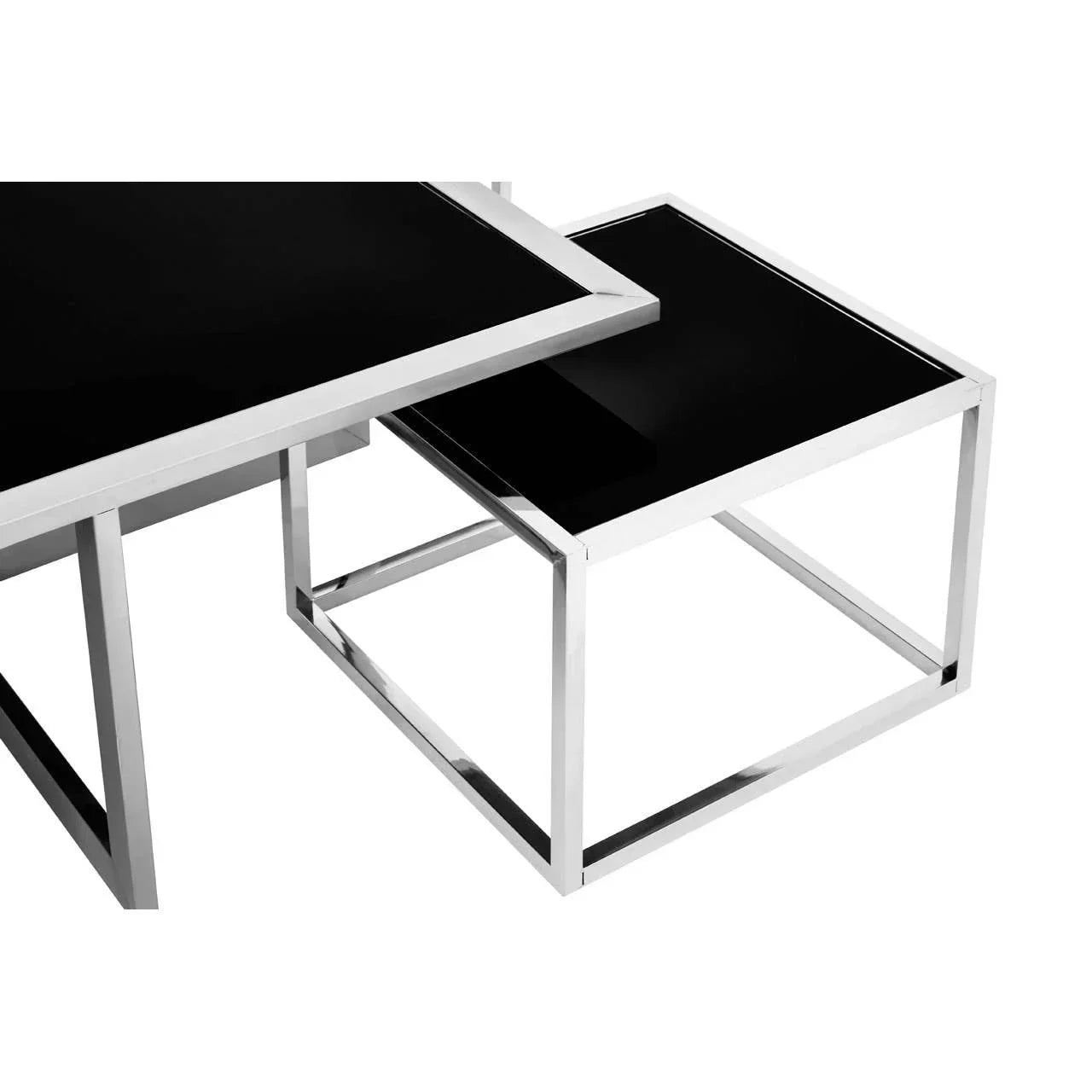 Black glass nesting tables with chrome metal frames, shown from a side corner angle