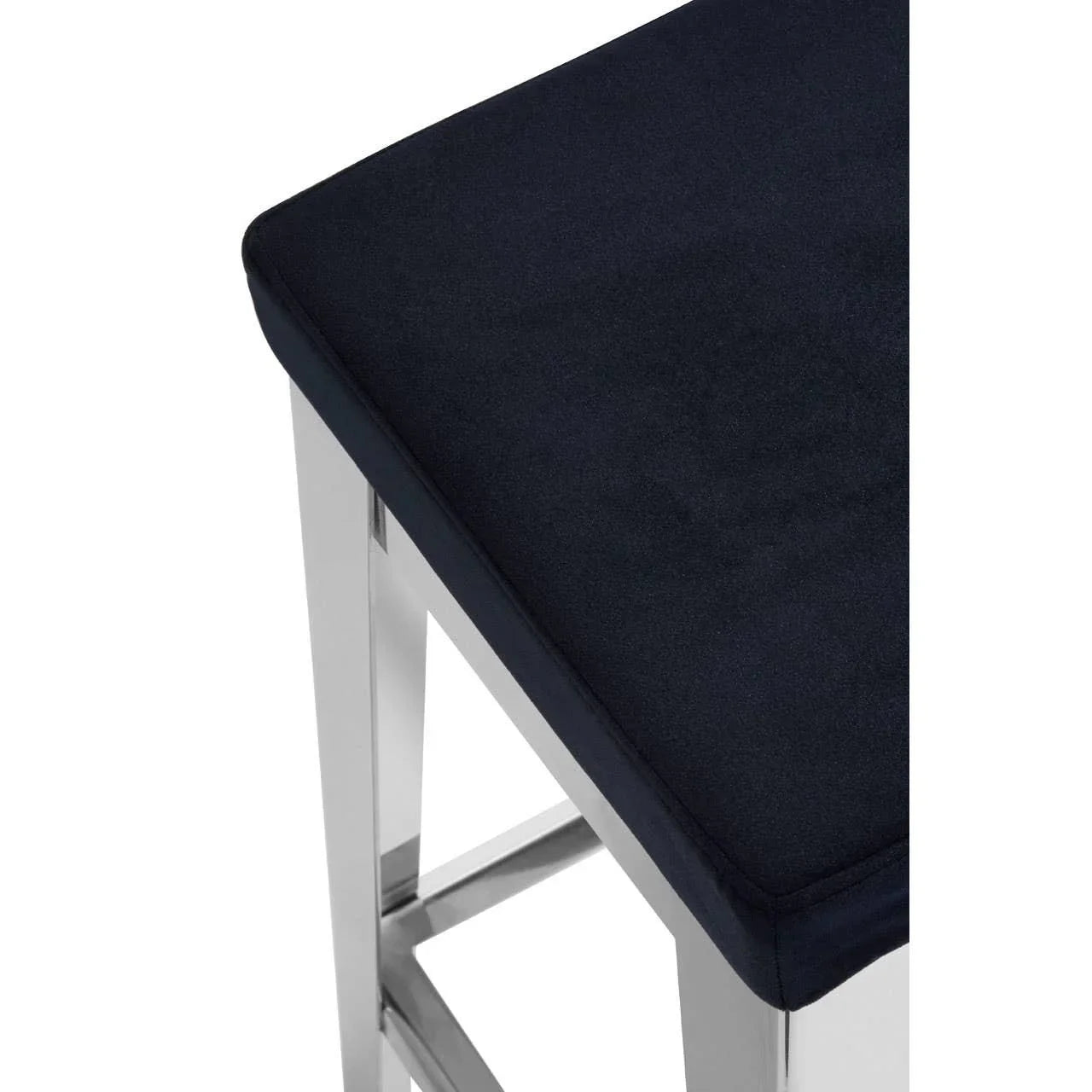 Black velvet bar stool seat with chrome legs, close-up view