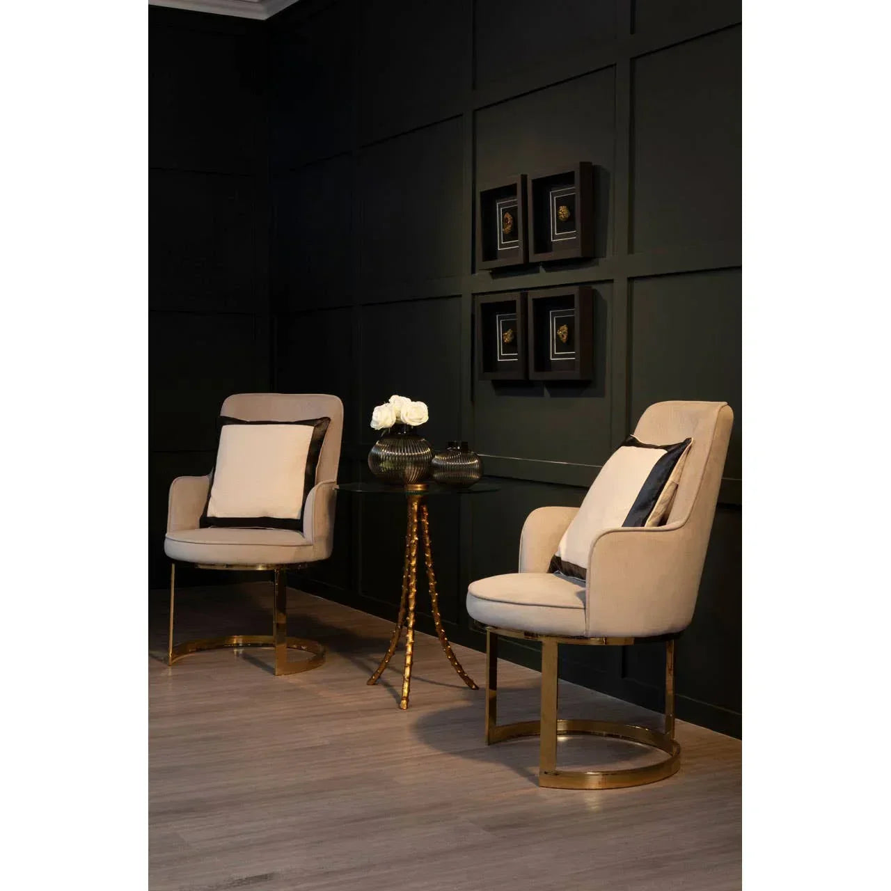 Beige accent chairs with gold metal frames and glass side table in modern living room setting