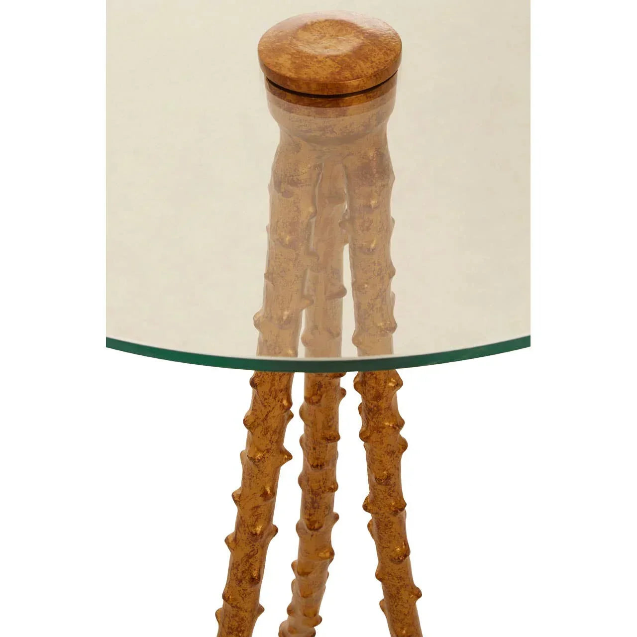 Round glass side table with carved wooden legs and natural wood finish