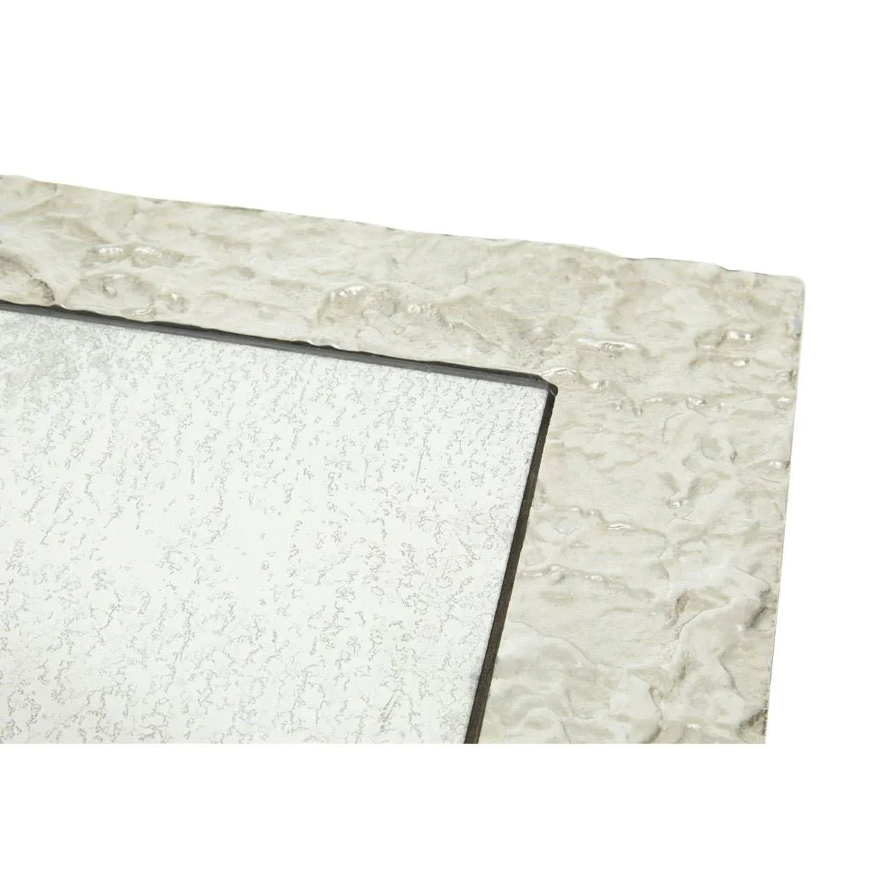 Close-up of textured silver mirror frame with metallic finish and beveled glass edge