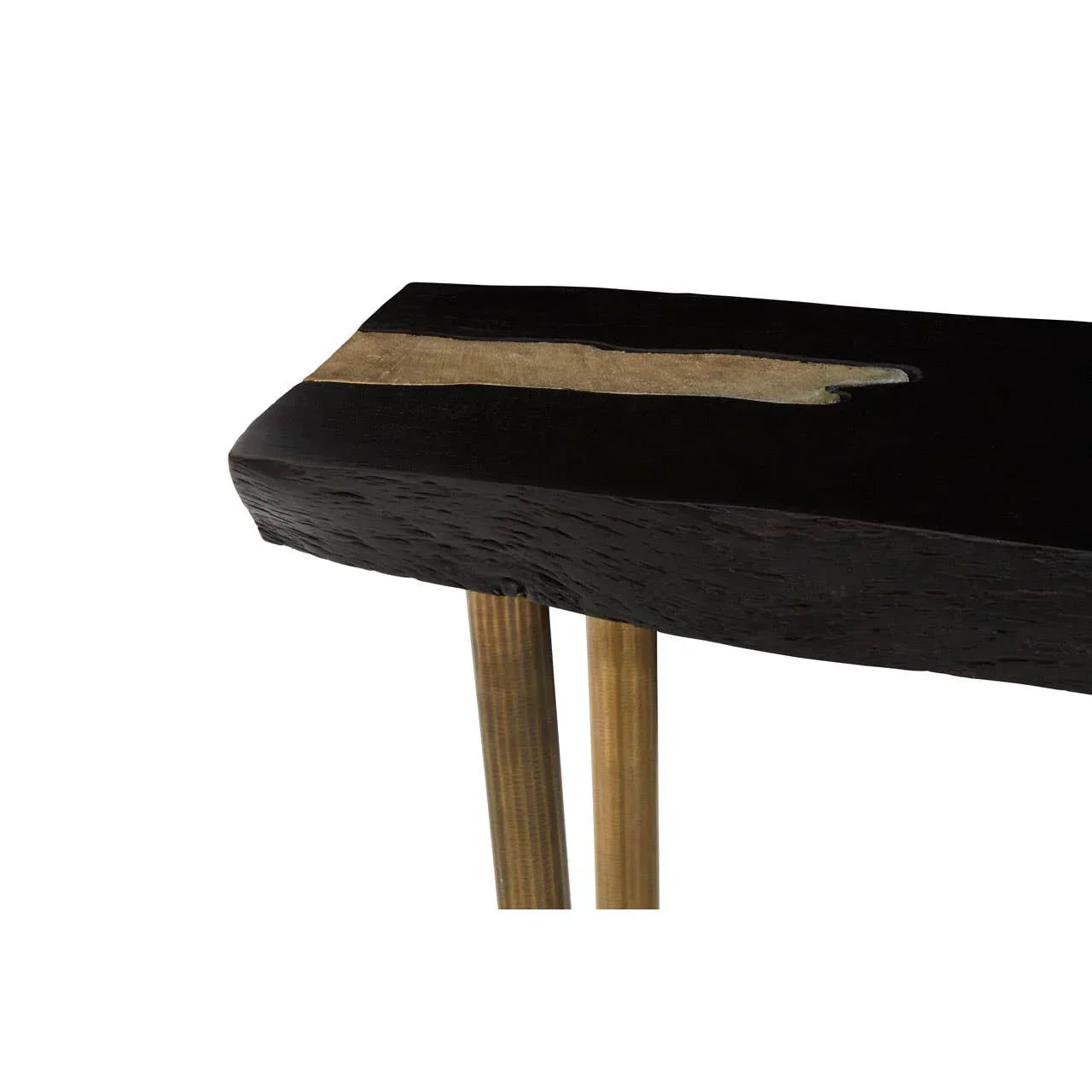 Closeup of black wood console table top with brass inlay and slim gold metal legs