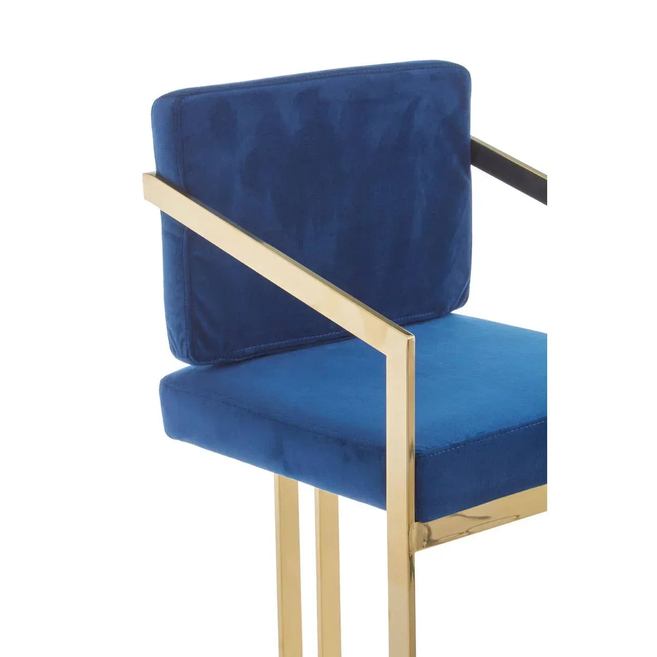 Blue velvet dining chair with gold metal frame and armrests, partial side view